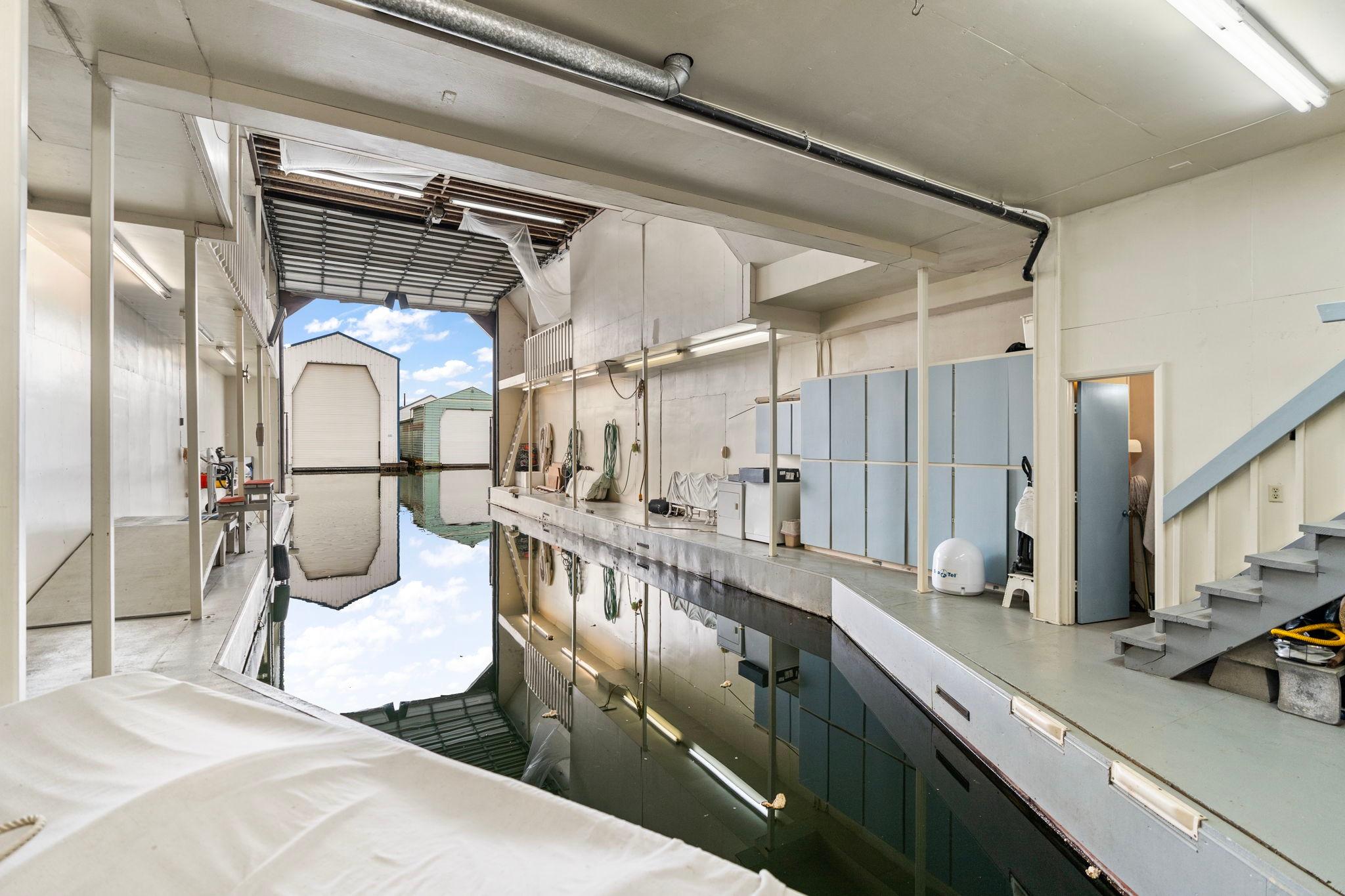 Interior of a 1976 custom boathouse with waterway and storage area.