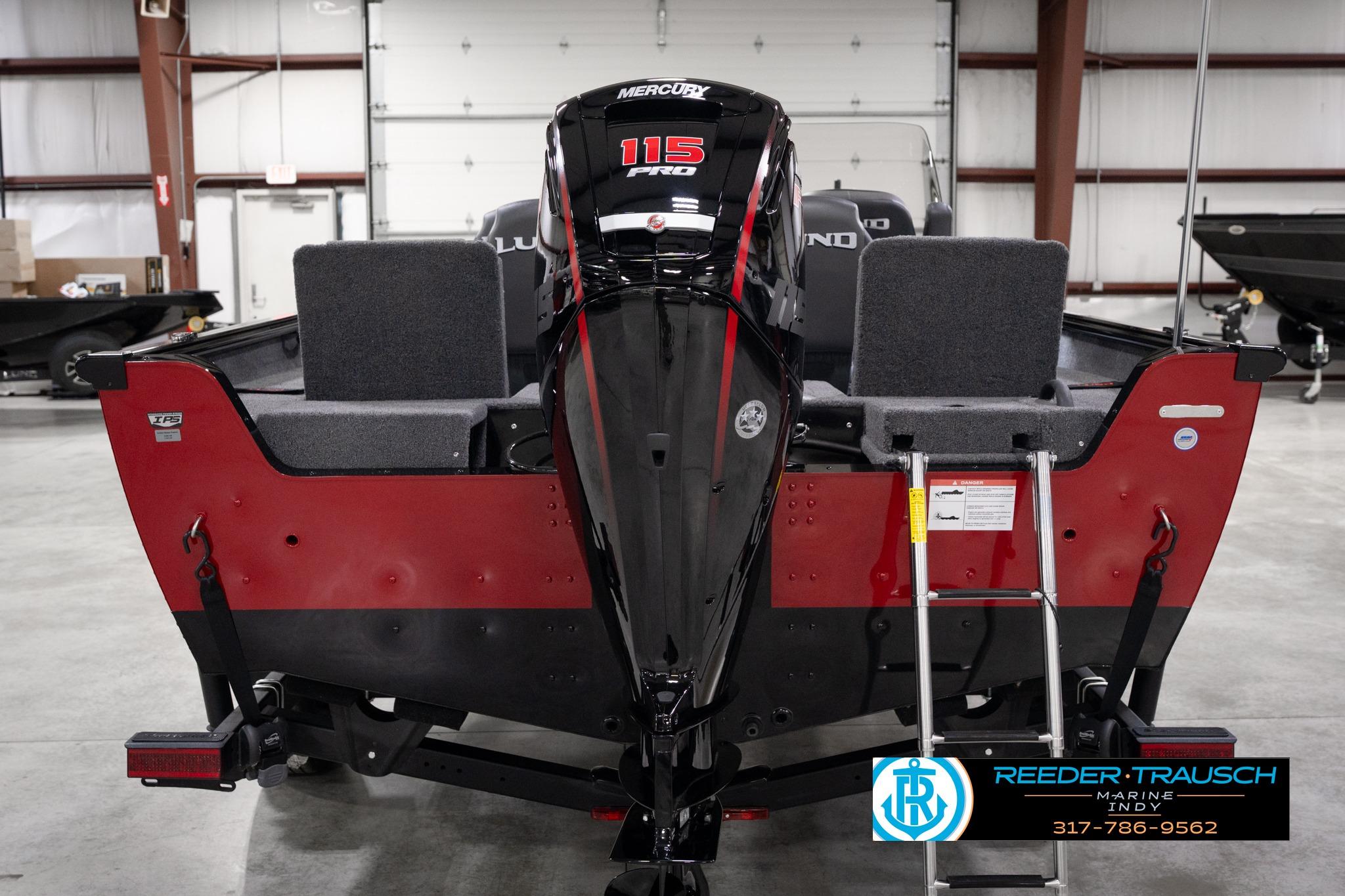 2026 Lund 1775 Impact XS SS boat with Mercury 115 Pro XS engine in showroom.
