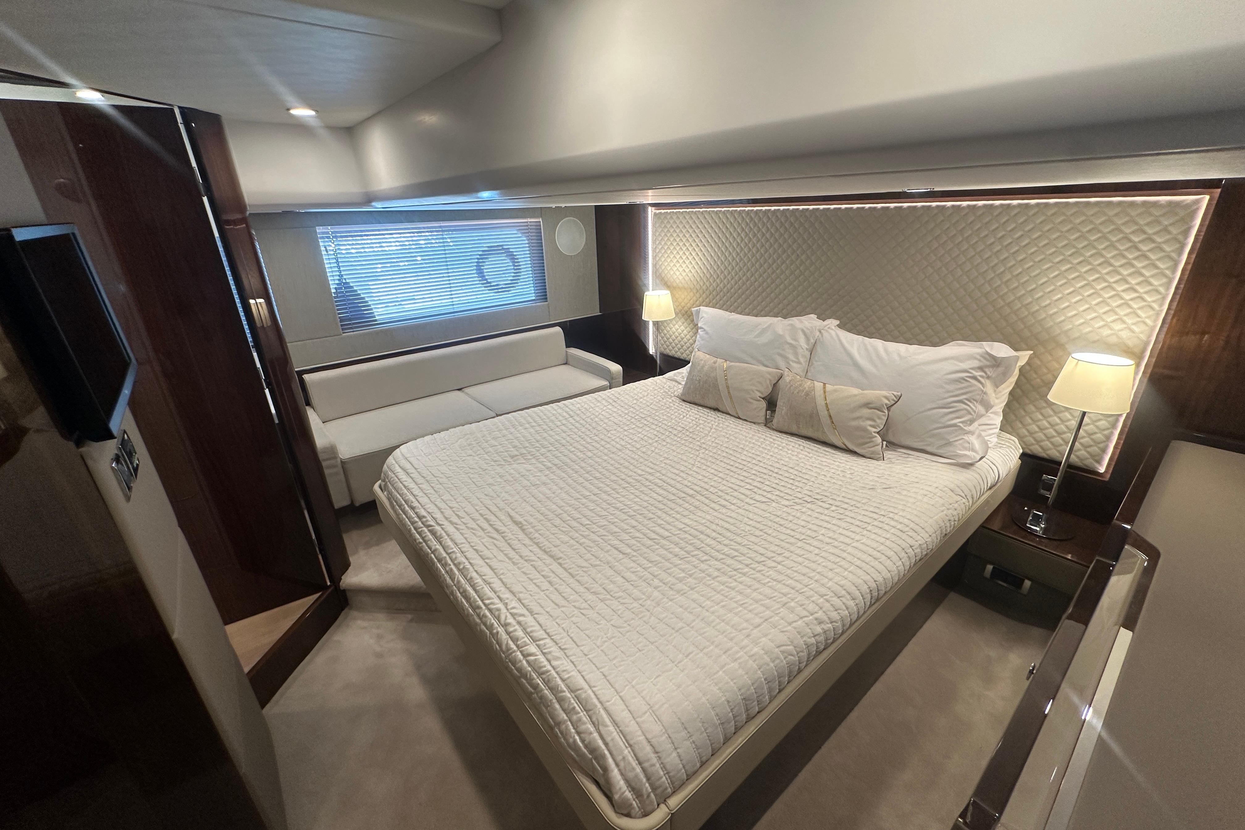 Luxurious bedroom interior of 2024 Fairline Squadron 50 yacht with elegant lighting and modern design.