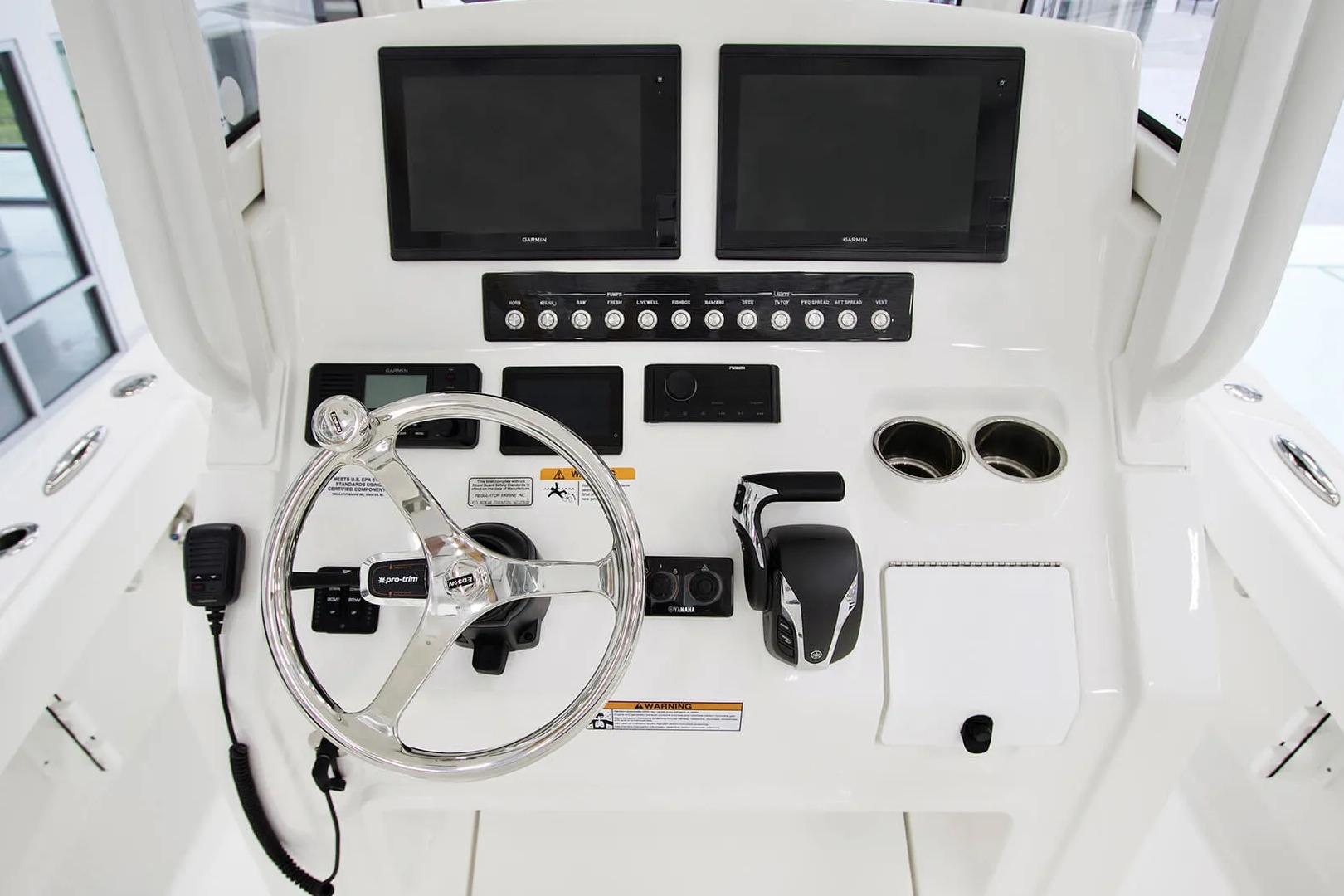 Helm of 2027 Regulator 24XO boat with steering wheel and control panel.