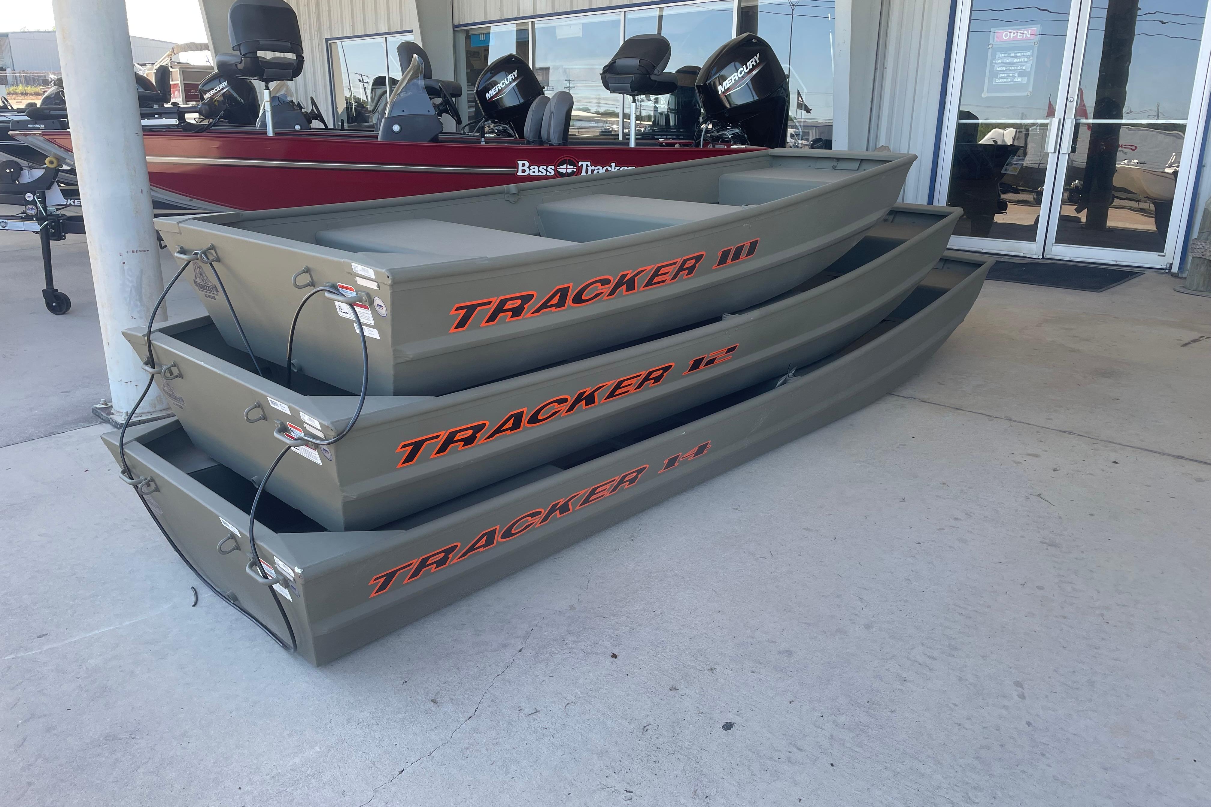 Stacked 2026 Tracker Grizzly 12 Jon boats displayed outside a dealership.