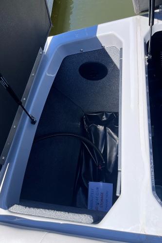 2024 Moomba Max storage compartment with open lid, showing interior details.