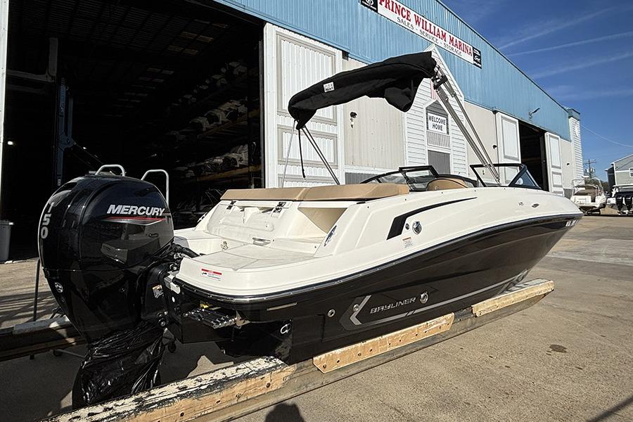 2023 Bayliner VR5 Bowrider OB with Mercury engine at marina dock.
