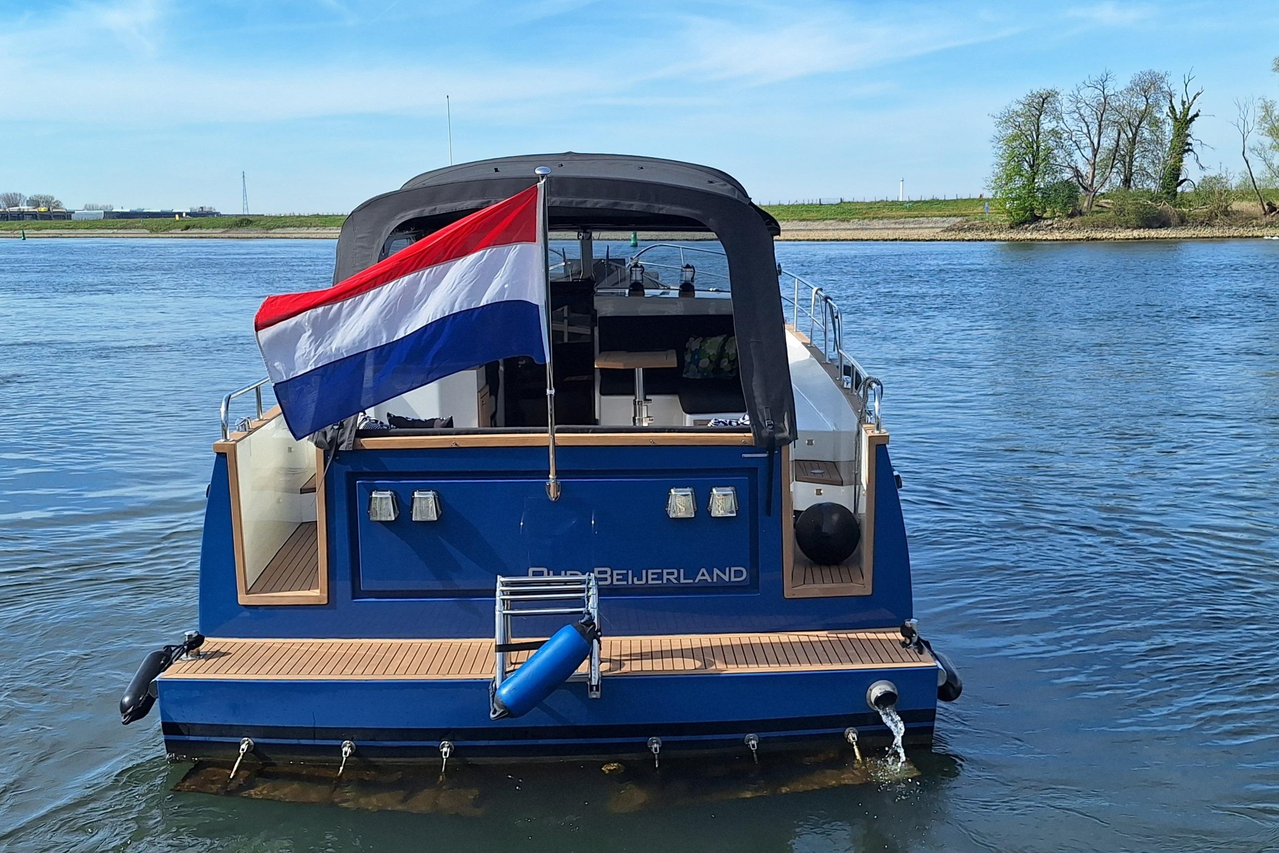 2023 Antaris X boat with Dutch flag on a serene river.