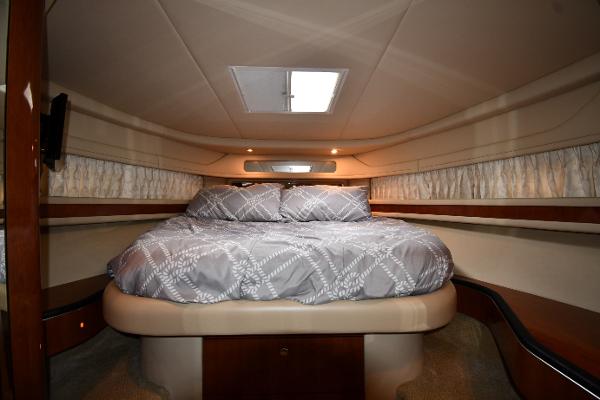 Luxurious cabin interior of 2003 Sea Ray 460 Sundancer yacht with cozy bed.