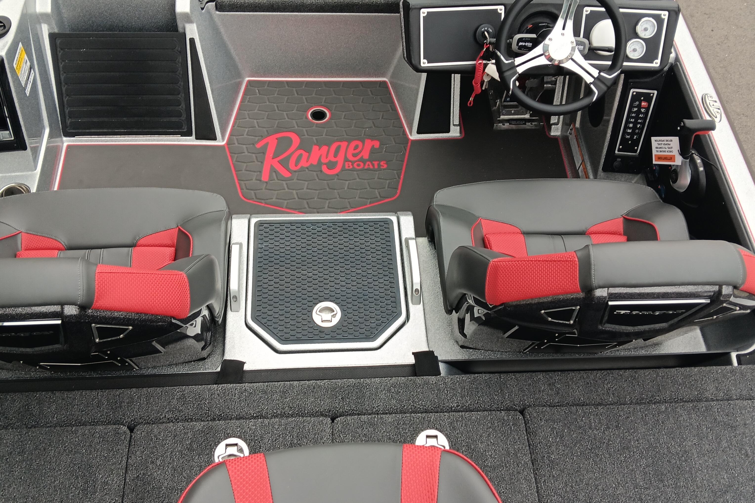 Interior of 2026 Ranger Z520 boat with red and black seating and steering console.