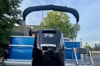 2026 Sun Tracker Party Barge 18 DLX with Mercury 75 engine, docked outdoors.