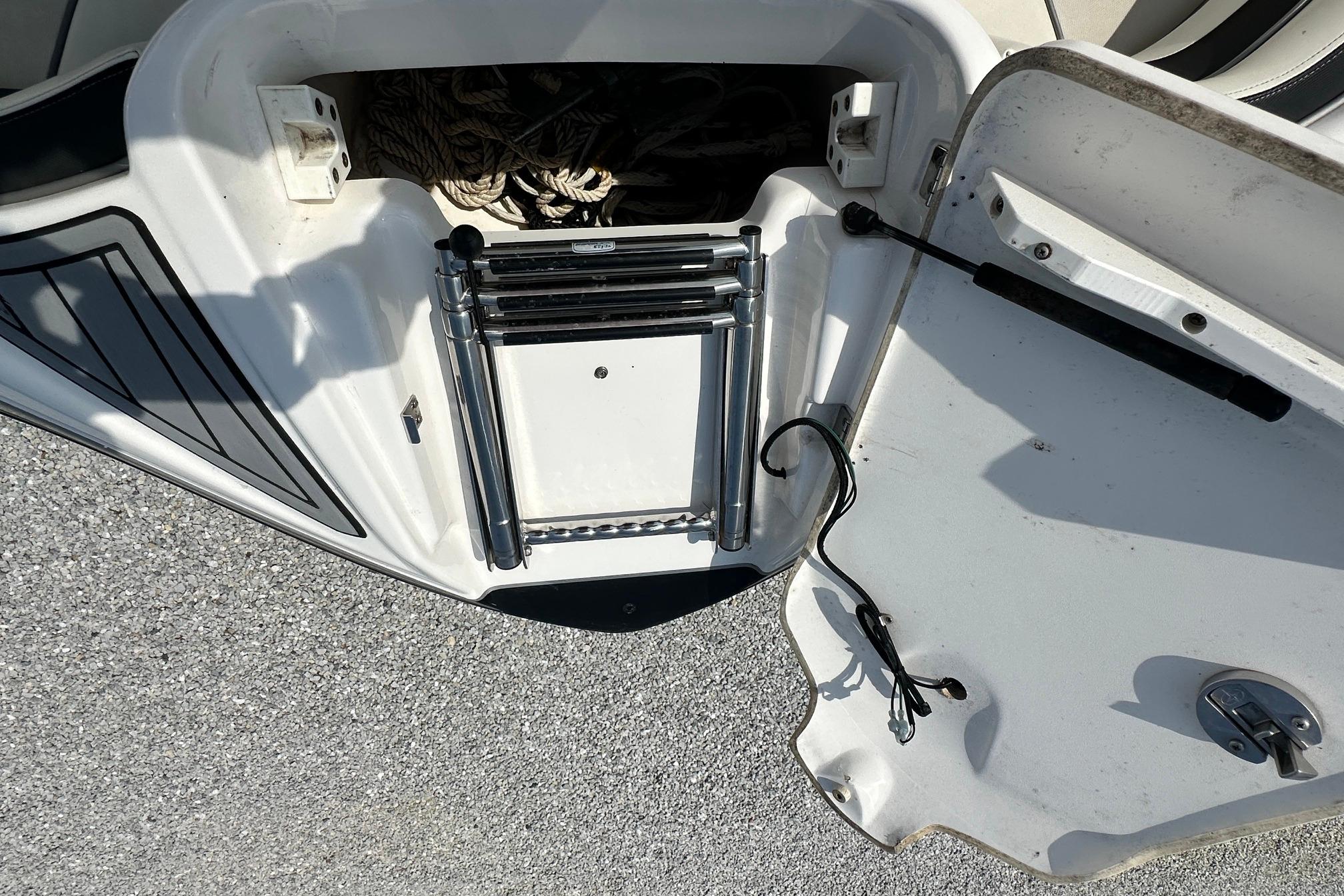 2016 Yamaha 242 Limited S swim platform with ladder and storage compartment.