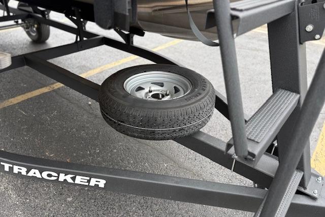 2026 Sun Tracker Party Barge 18 DLX trailer with spare tire.