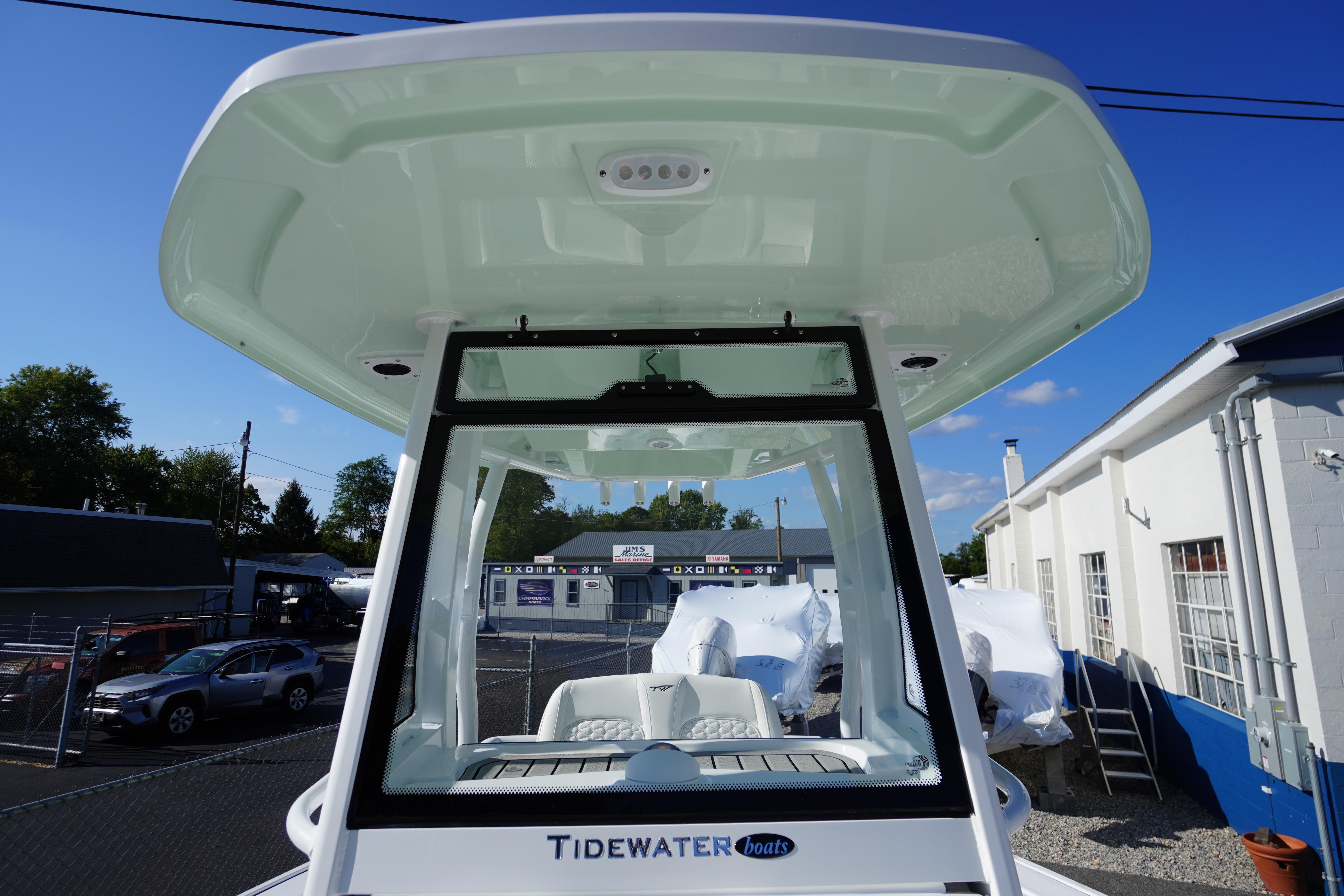 2026 Tidewater 272 LXF boat with hardtop, parked outdoors under clear blue sky.