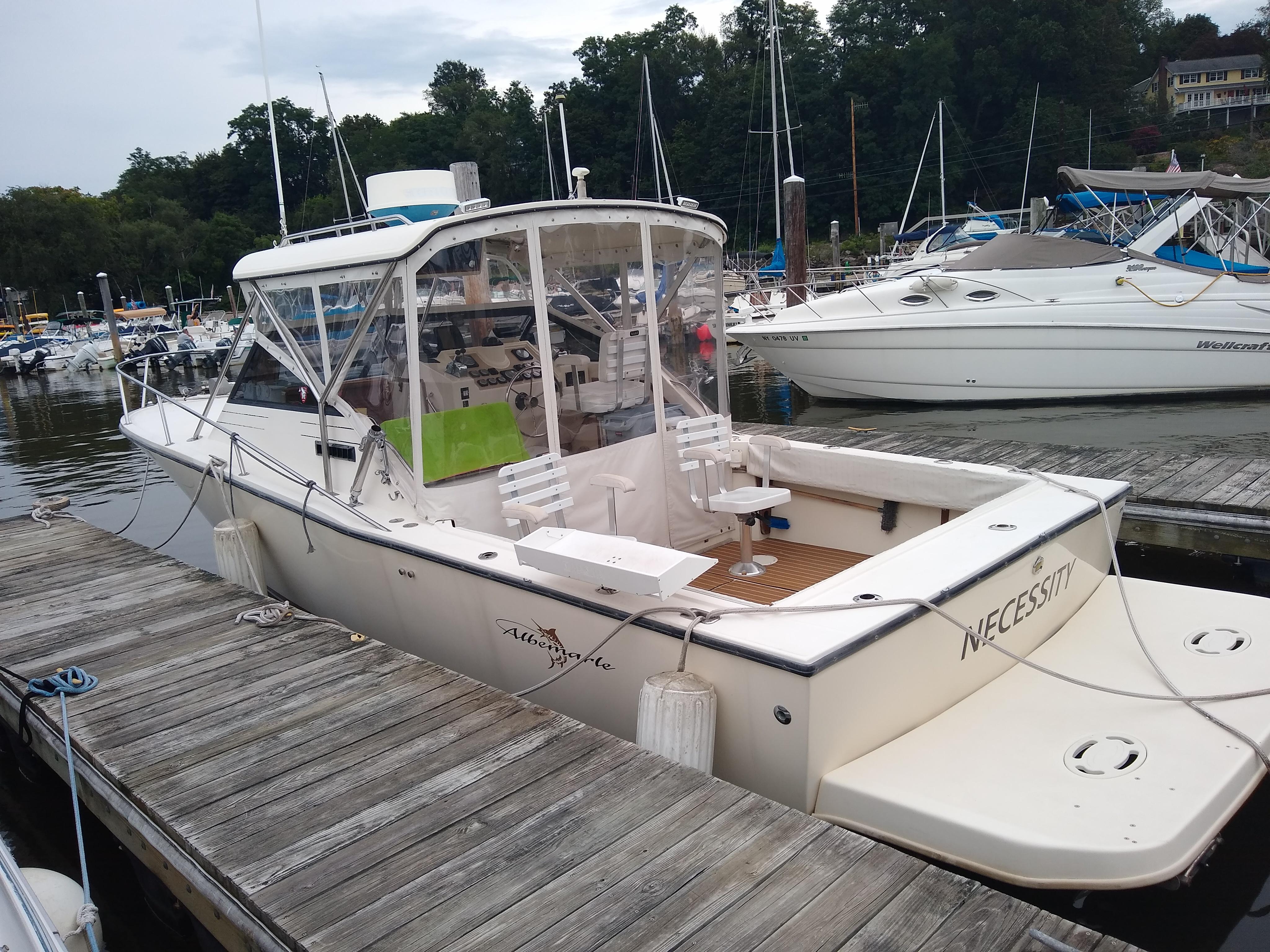 1988 Albemarle 27 Express Fisherman boat docked at marina, surrounded by other boats.