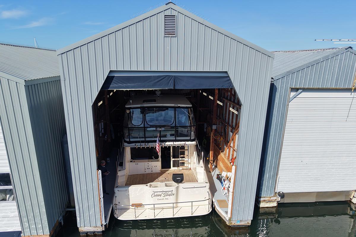 2004 Mikelson 50 Luxury Yacht docked in a covered marina slip.
