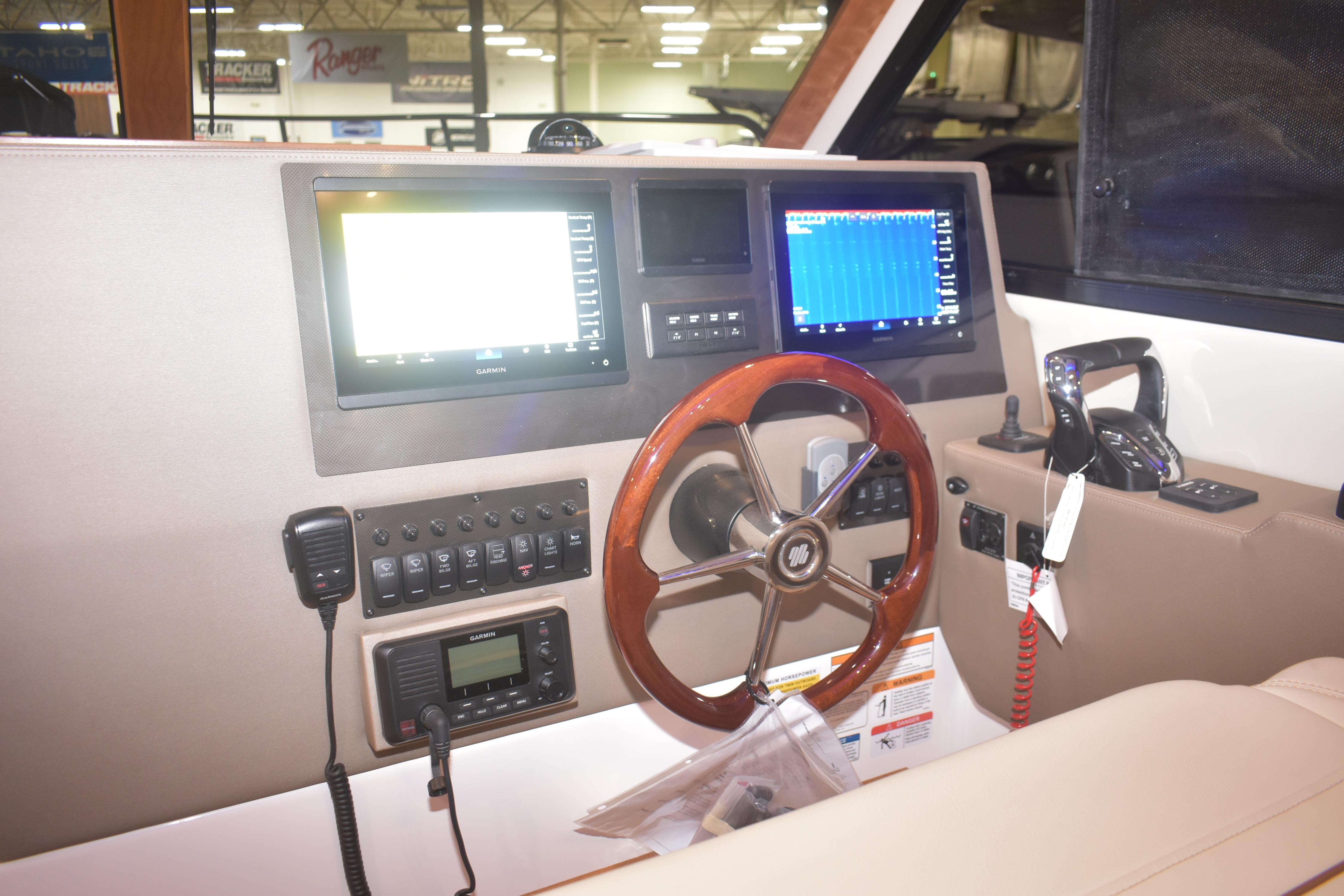 Helm of 2026 Cutwater C-32 CB with advanced navigation displays and controls.