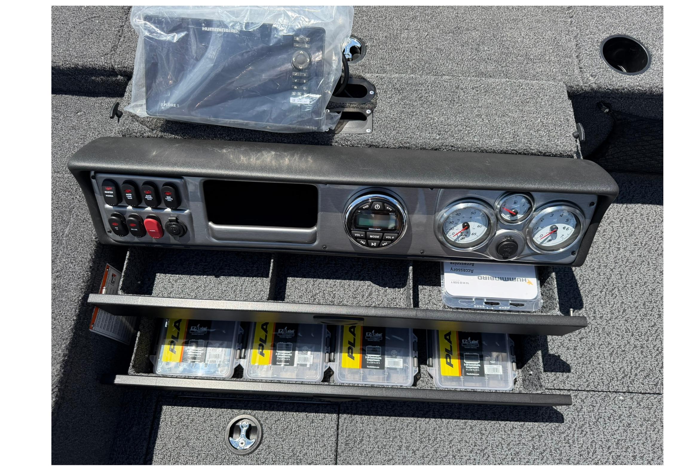 Control panel of 2027 Lund 1875 Pro Guide boat with gauges and storage compartments.