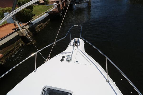 Bow of 1992 Sea Ray 350 Express Bridge docked in a marina.