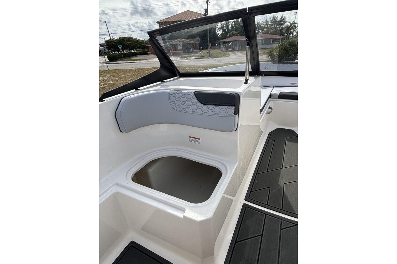 2025 Bayliner Element M17 boat interior with seating and storage compartment.