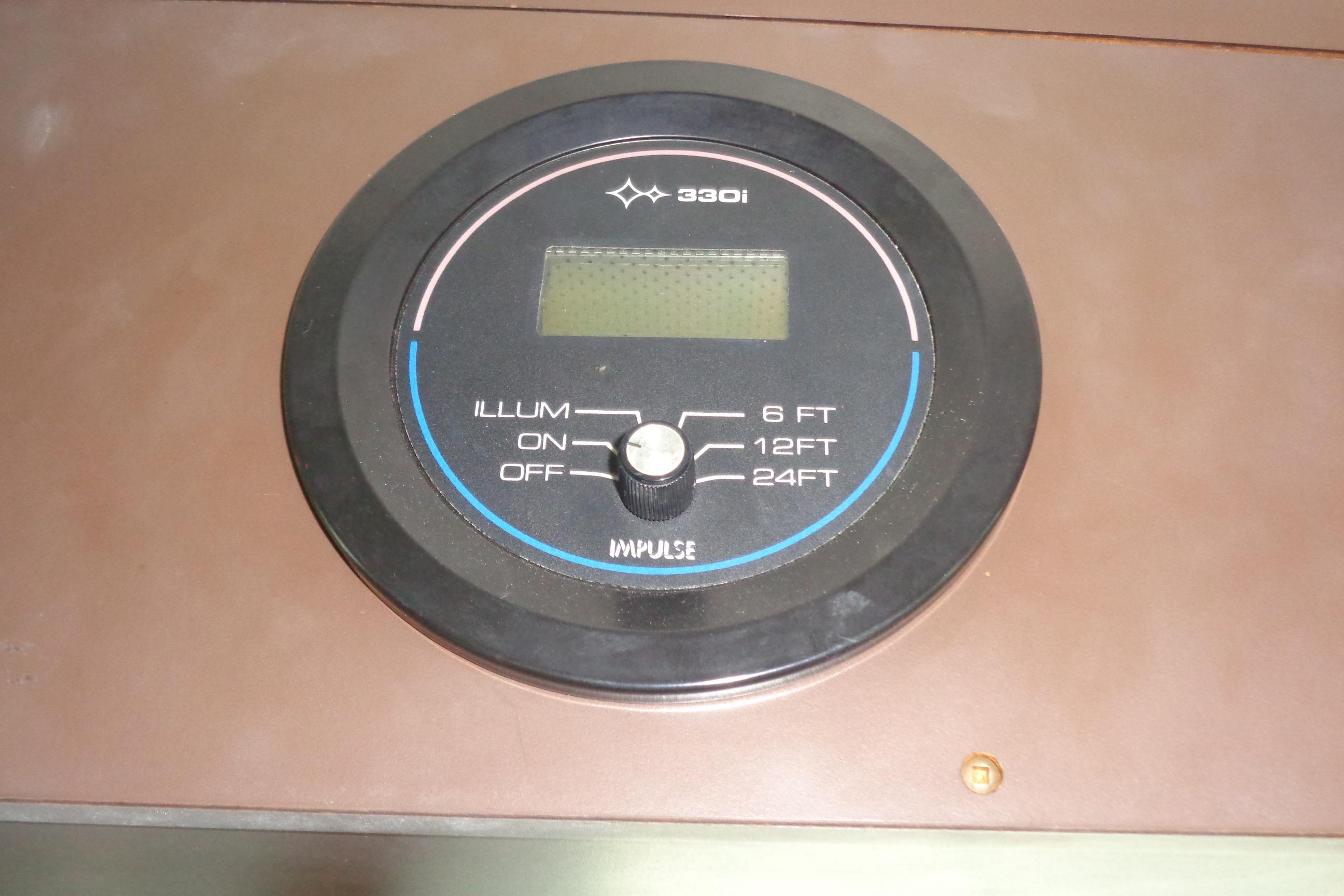 Depth gauge on 1981 Hatteras 48 Cockpit Motor Yacht dashboard, showing illumination and depth settings.