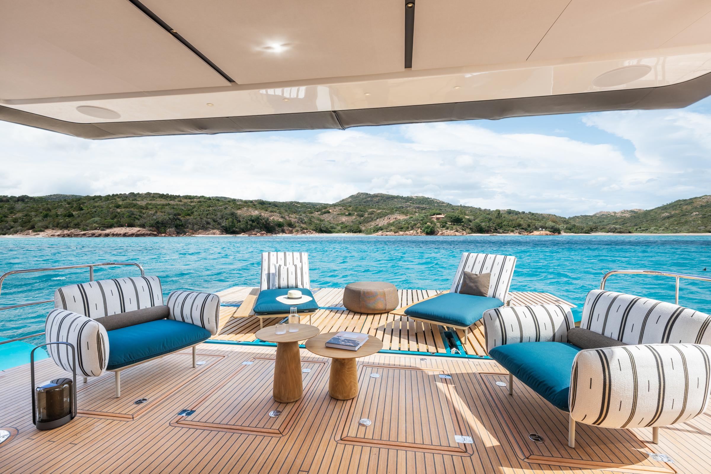 Luxurious Lagoon Eighty 2 yacht deck with stylish seating, overlooking serene blue waters, 2025 model.