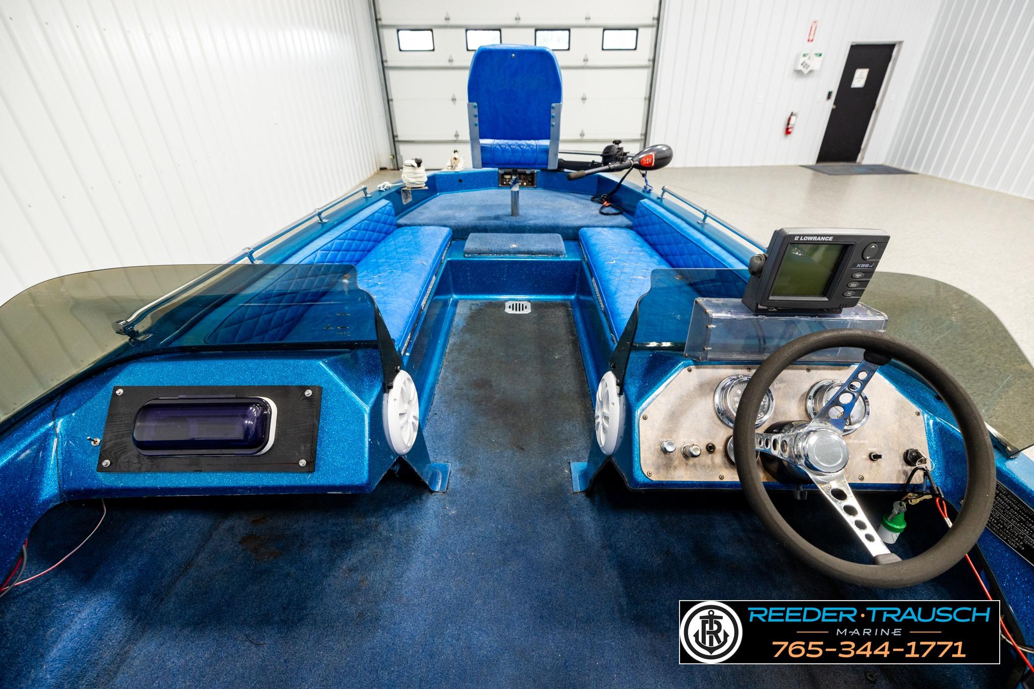 1980 Ranger 175 VS boat interior with blue seating and steering console.