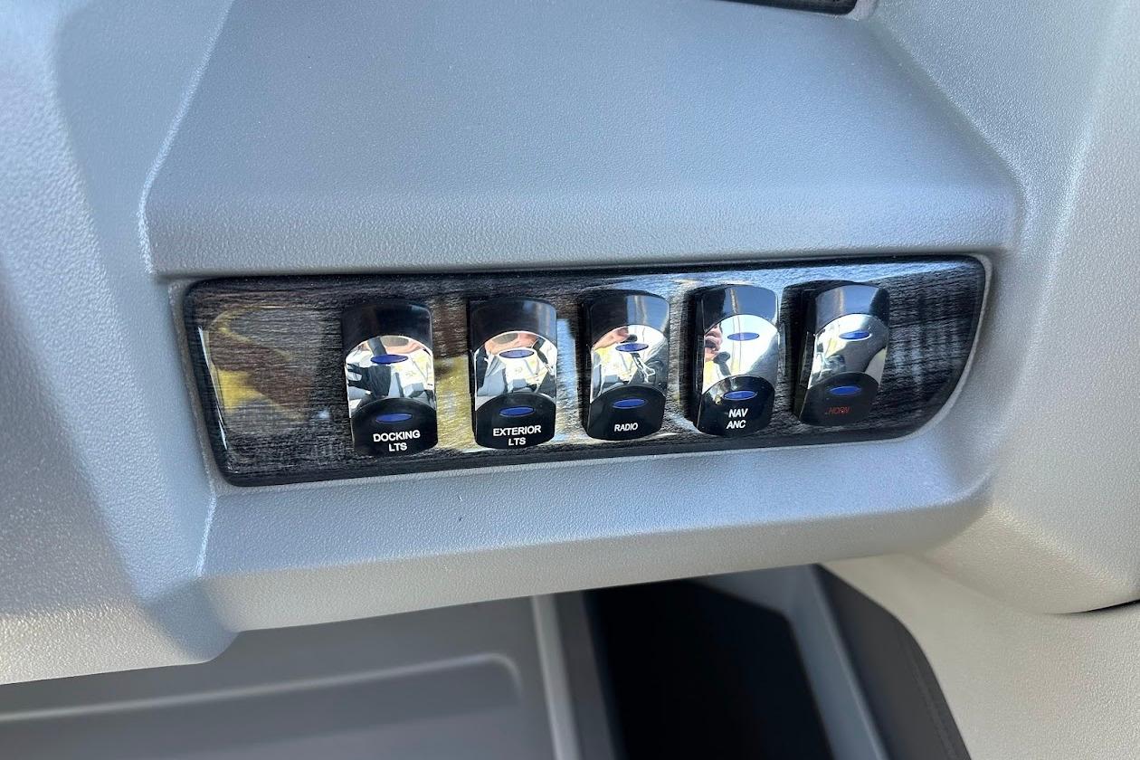Control panel of 2026 Tahoe Pontoon LTZ Quad Lounger Shift 23 with labeled switches.
