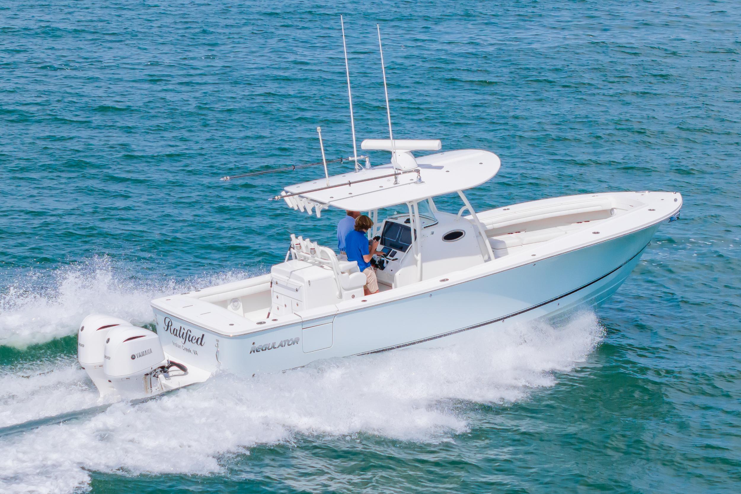 2019 Regulator 31 boat cruising on open water with twin Yamaha engines.