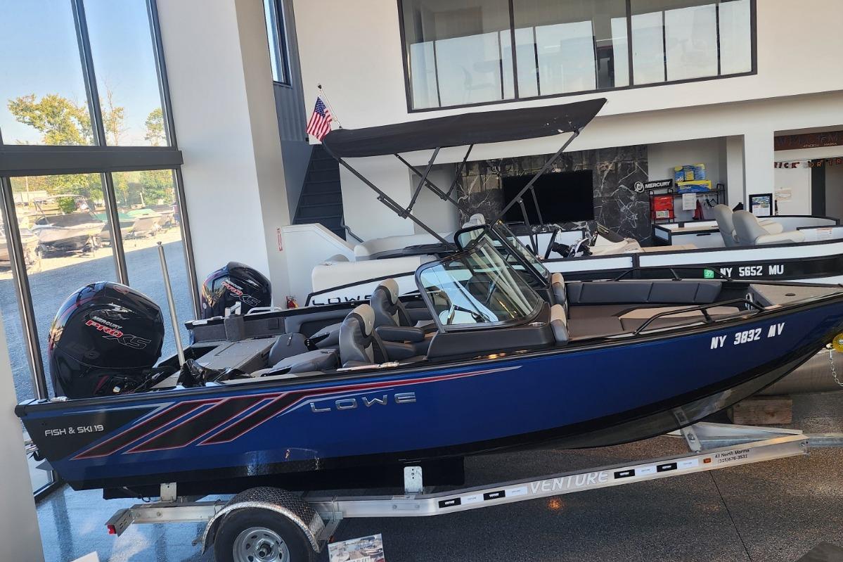 2023 Lowe Fish & Ski 19 boat displayed indoors on a trailer.
