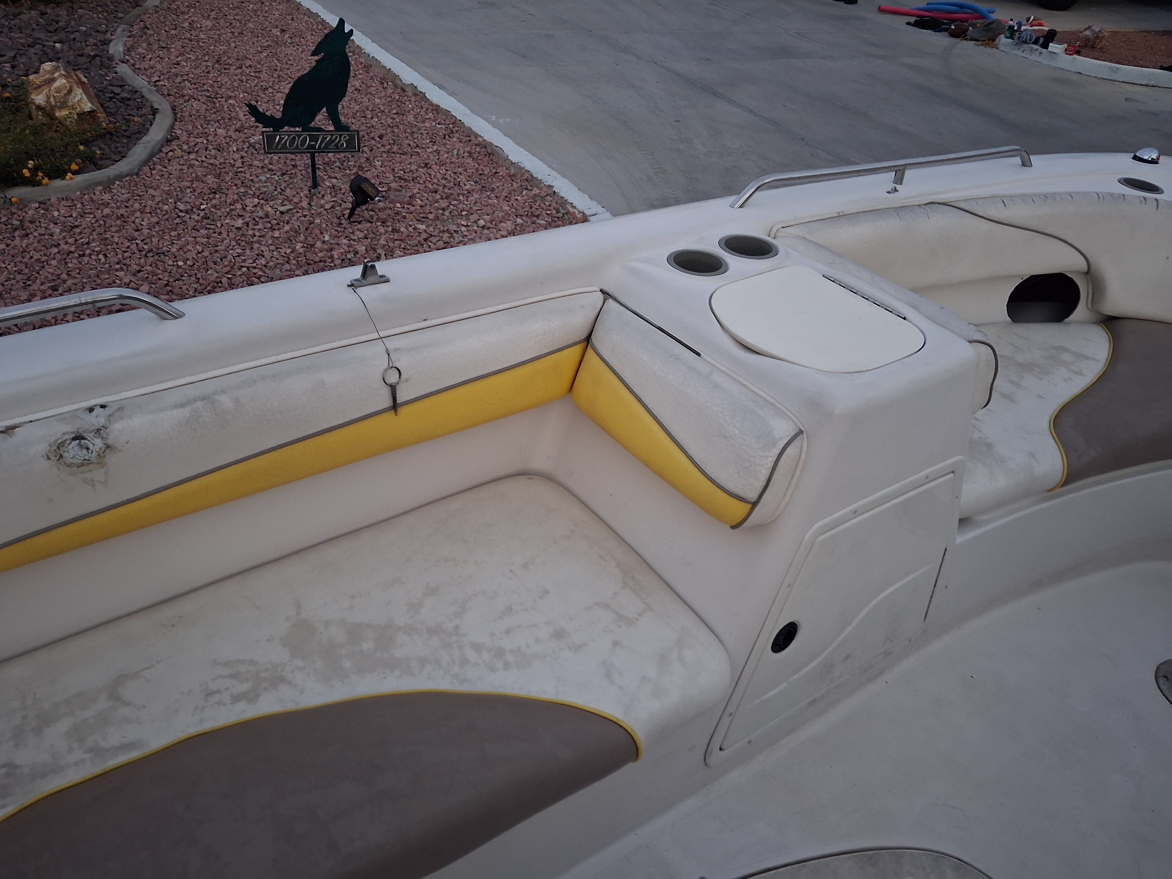 Interior of a 2004 Tracker Tahoe boat with yellow accents.