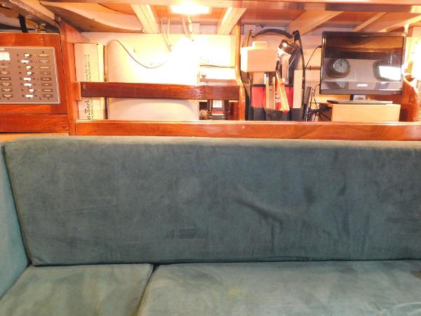 Interior of 1983 Custom Murray Peterson Coaster III with green sofa and wooden accents.