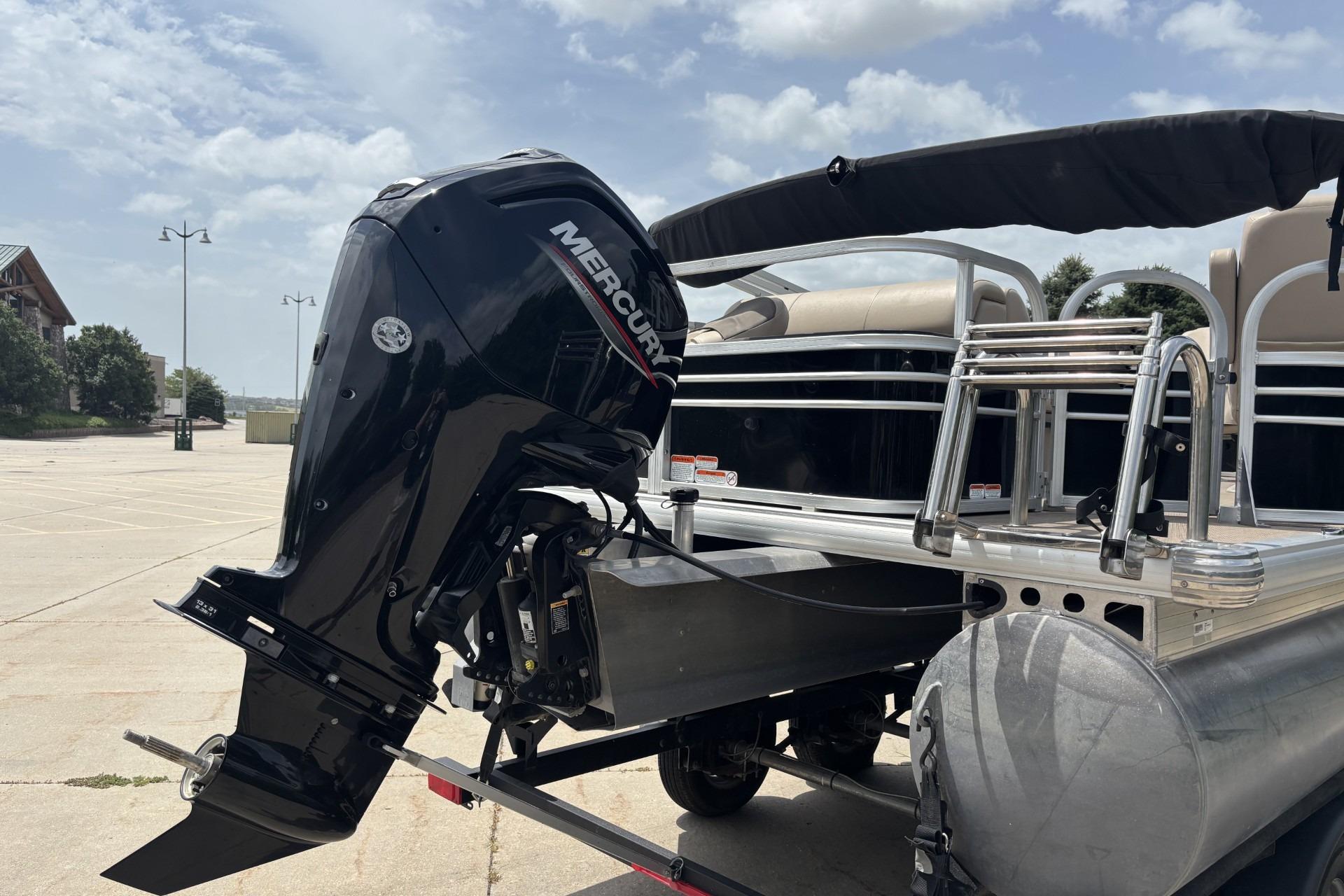 2023 Sun Tracker SportFish 20 DLX pontoon boat with Mercury outboard motor.