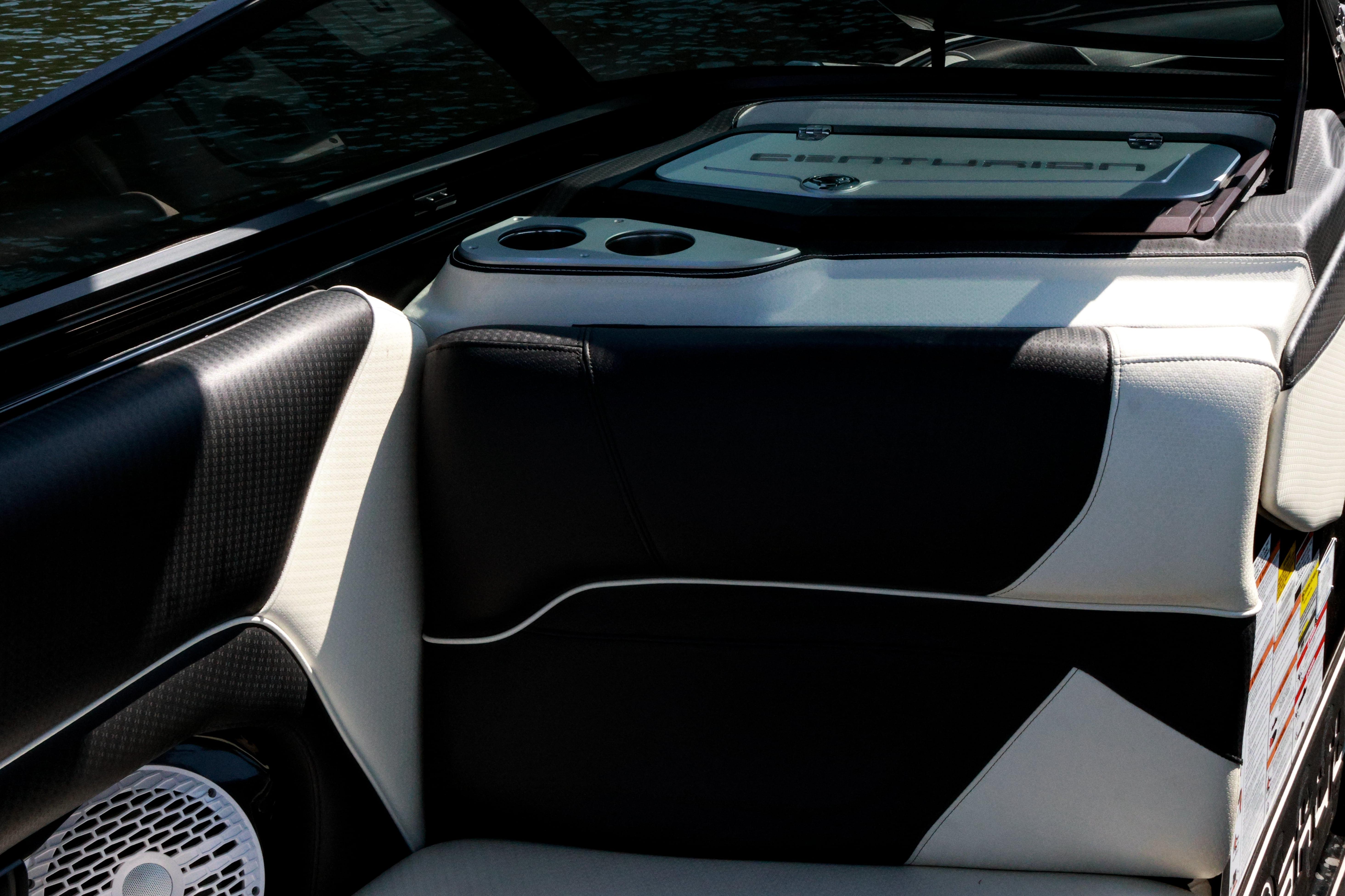 Interior of 2022 Centurion Ri265 boat with black and white seating and cup holders.