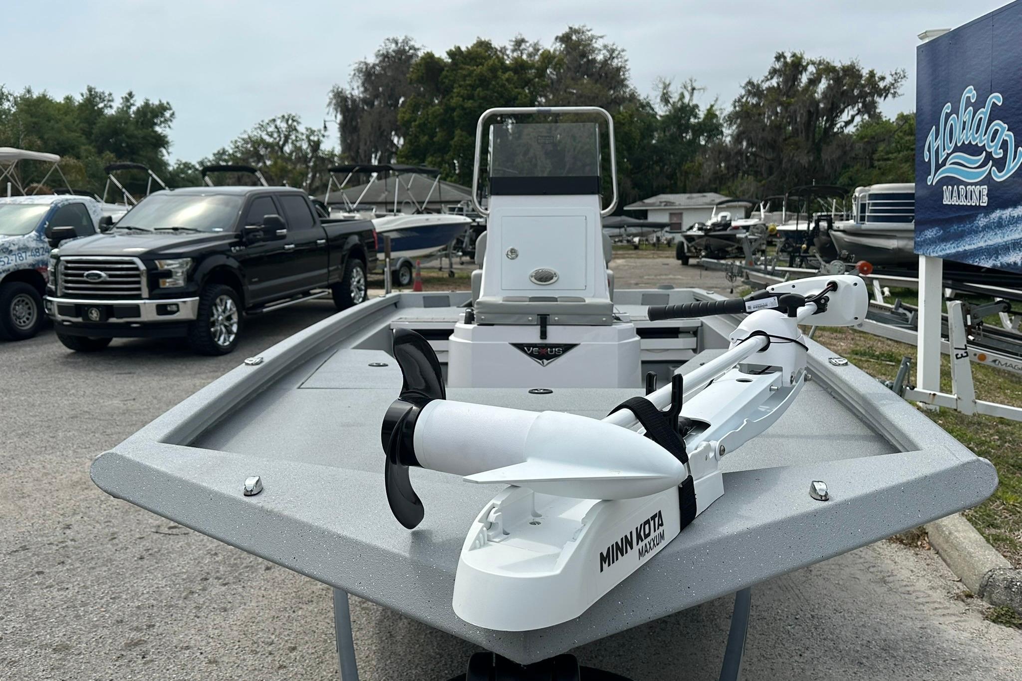 2026 Vexus Defender 201 boat with Minn Kota trolling motor at Holiday Marine dealership.