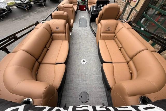 Luxurious 2026 Regency 230 DL pontoon boat with spacious tan seating and modern design.