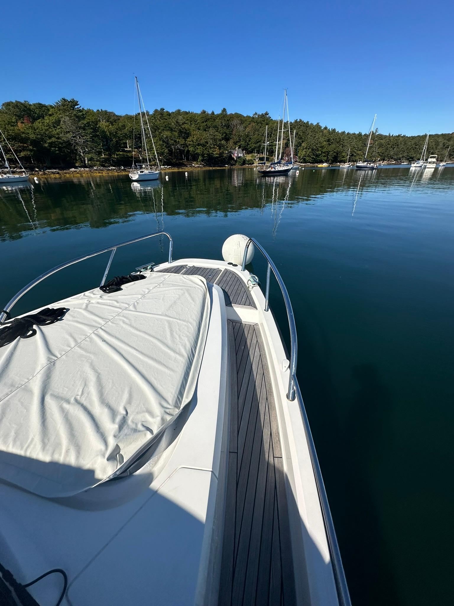 Nimbus W9 2021 boat on calm water with forested shoreline in background.