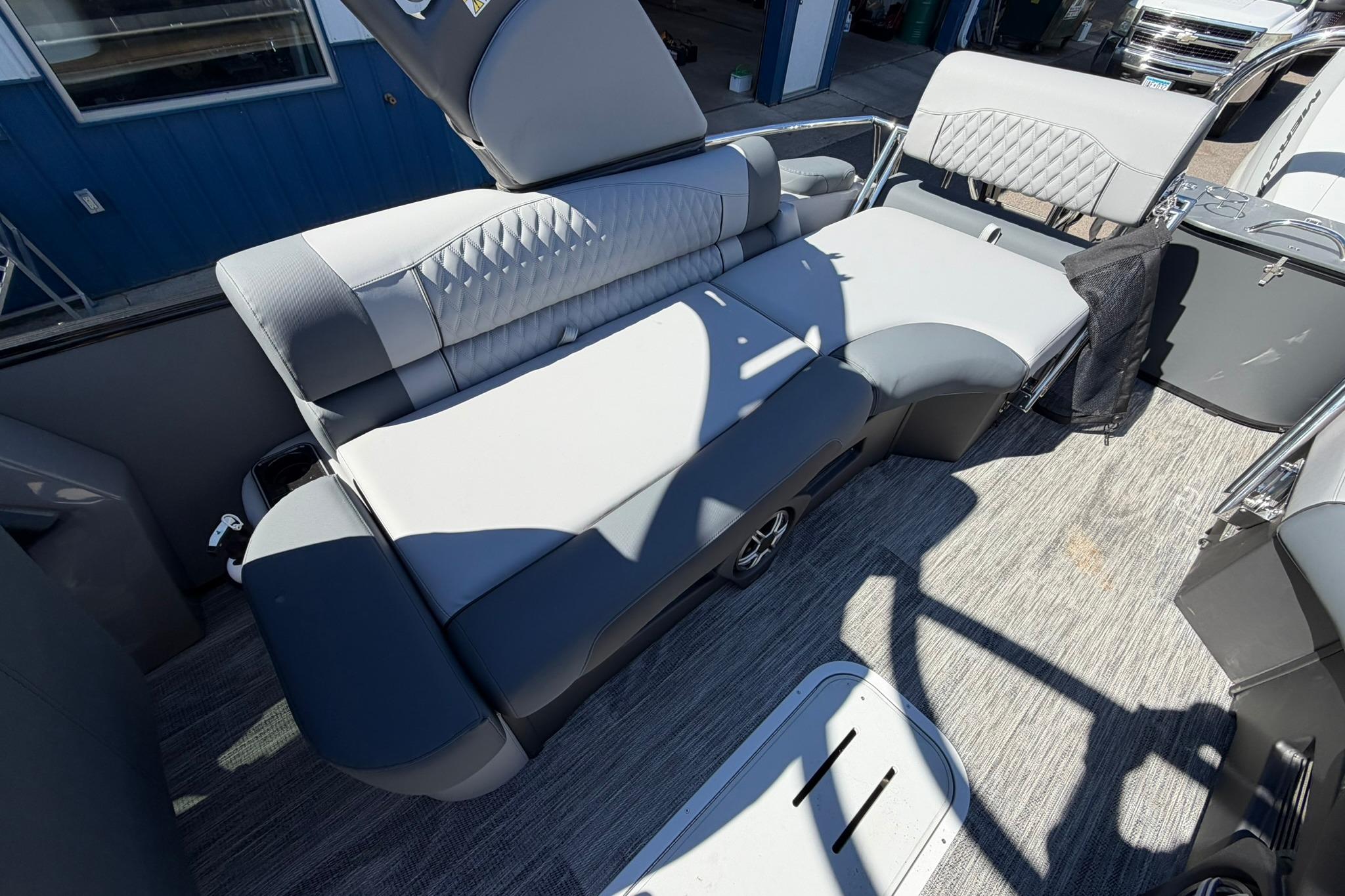 Luxurious seating on 2026 Avalon Excalibur LTD Quad Lounge Windshield boat, featuring elegant upholstery.