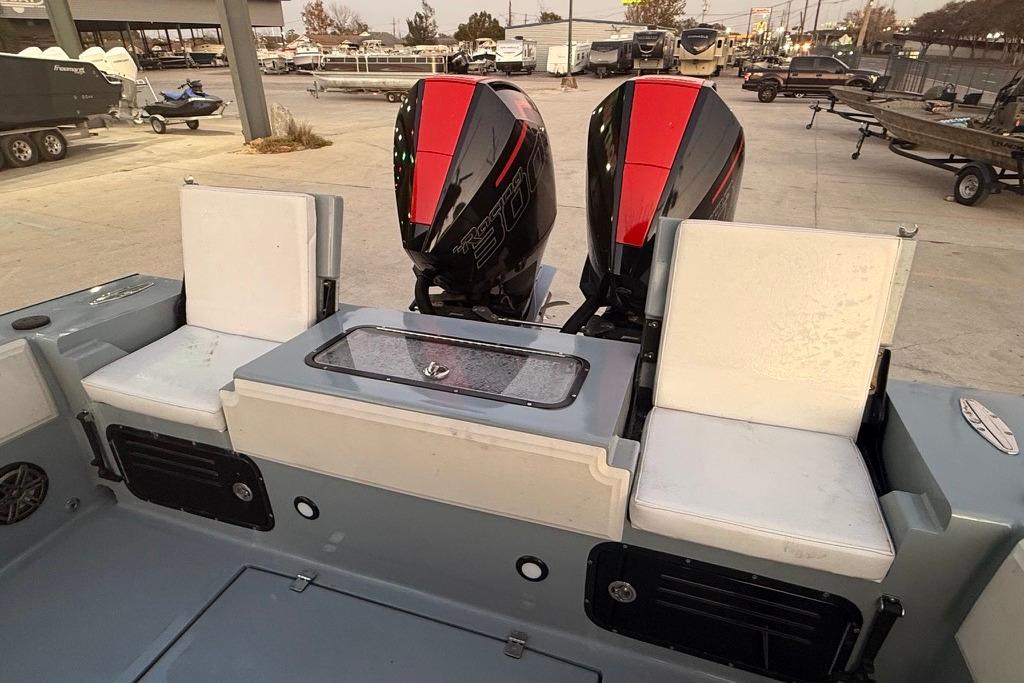 2019 Metal Shark 28 CC boat with dual engines and seating in a marina setting.