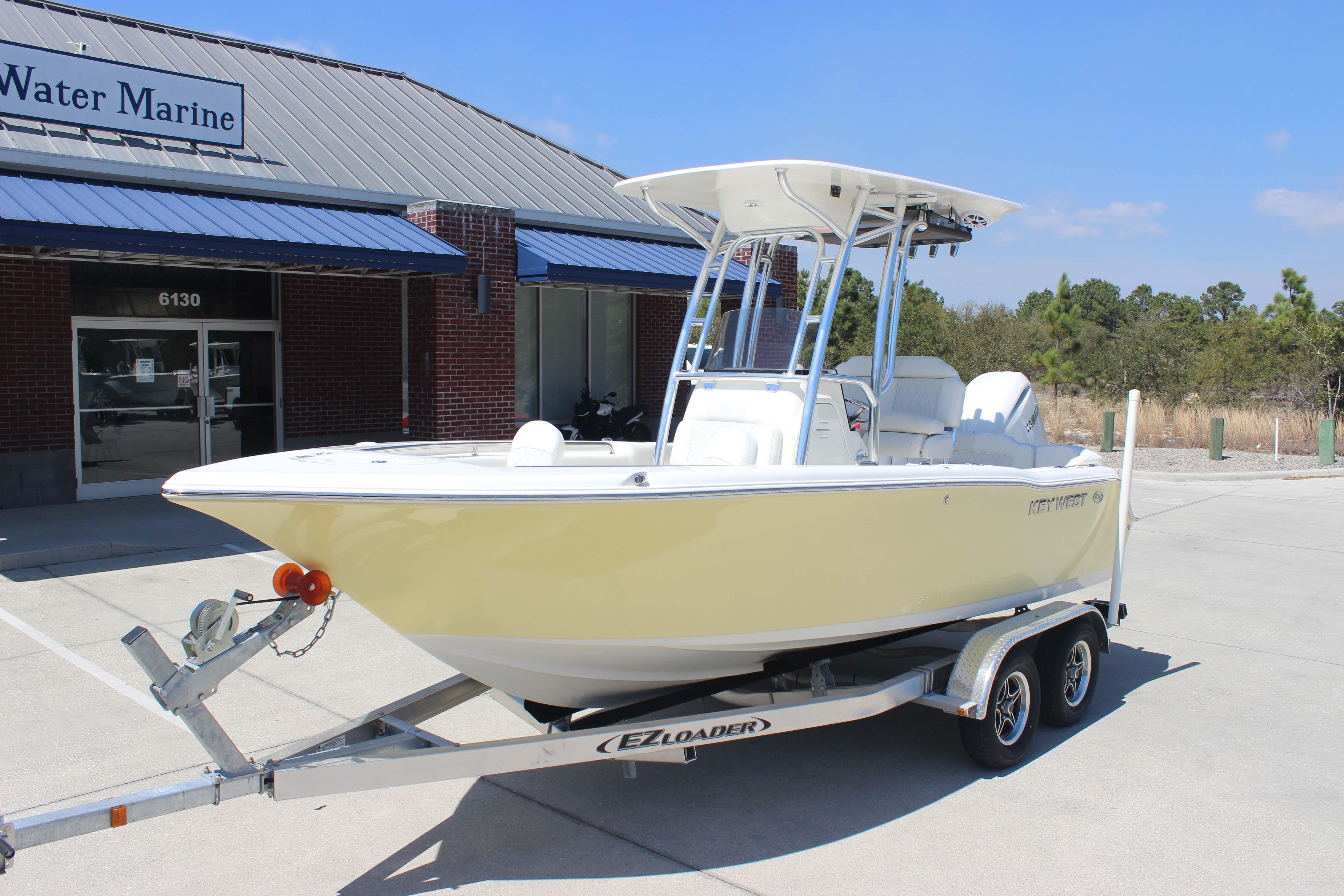 2026 Key West 203 FS boat on trailer outside marine dealership.