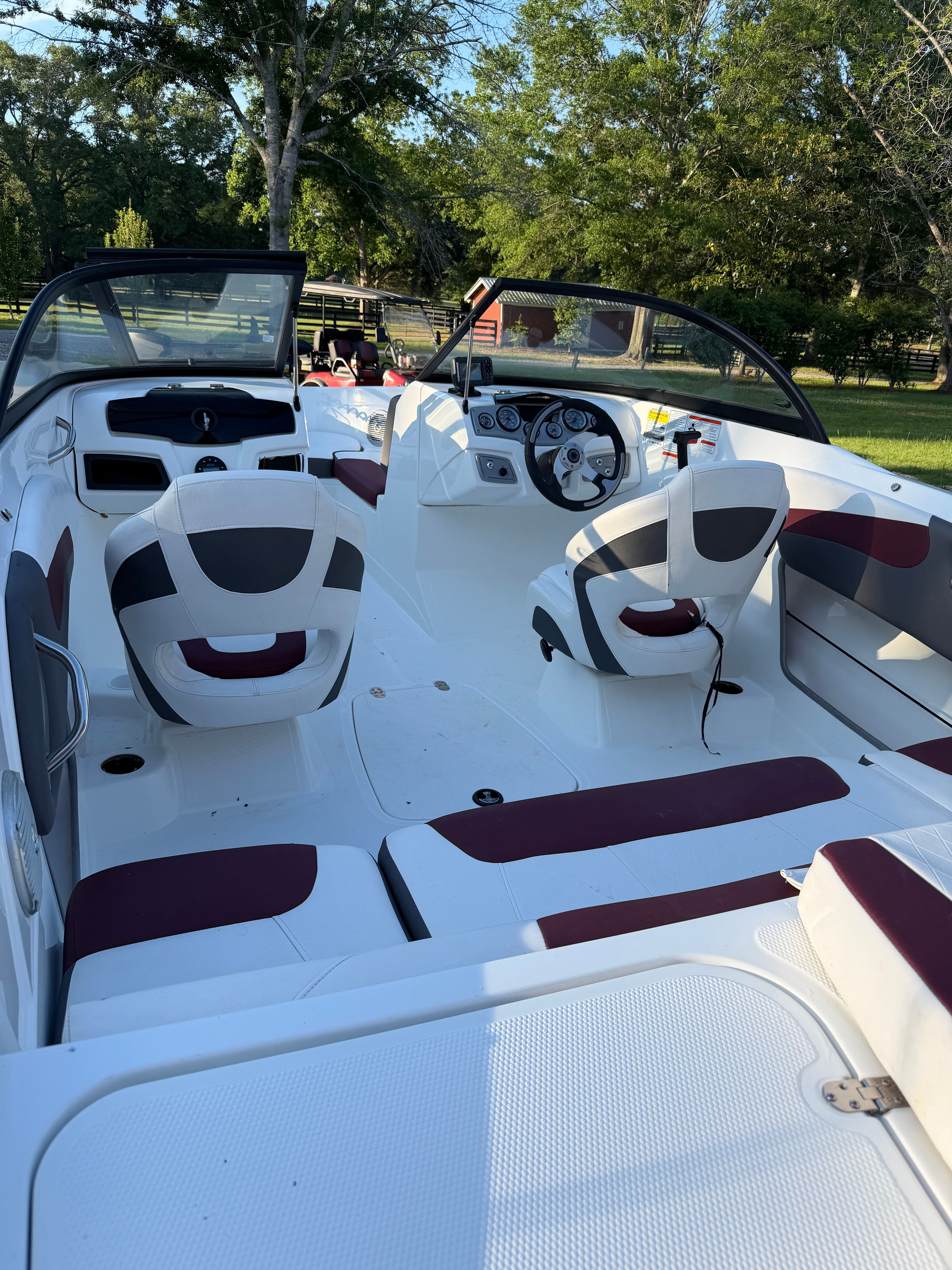 Interior of a 2020 Tracker Tahoe 550TF boat with seating and steering.
