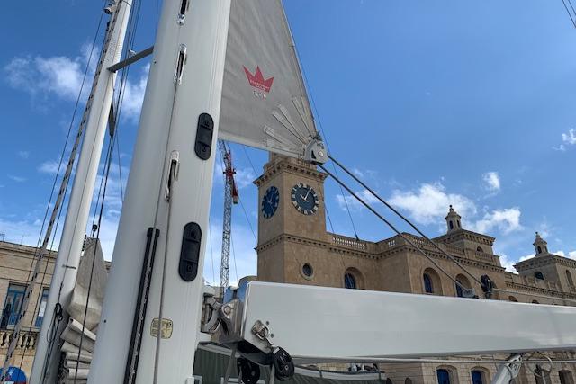 Sailboat Hanse 588 (2017) mast with historic building and clock tower in the background.