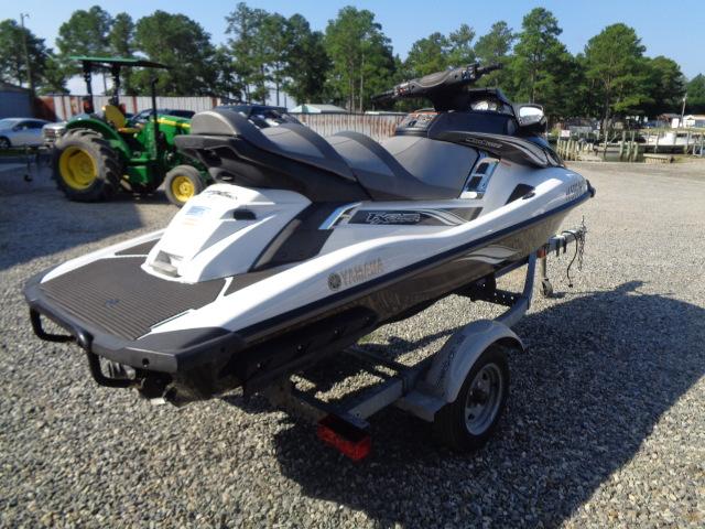 2015 Yamaha WaveRunner FX Cruiser H/O on trailer, parked on gravel with trees in background.