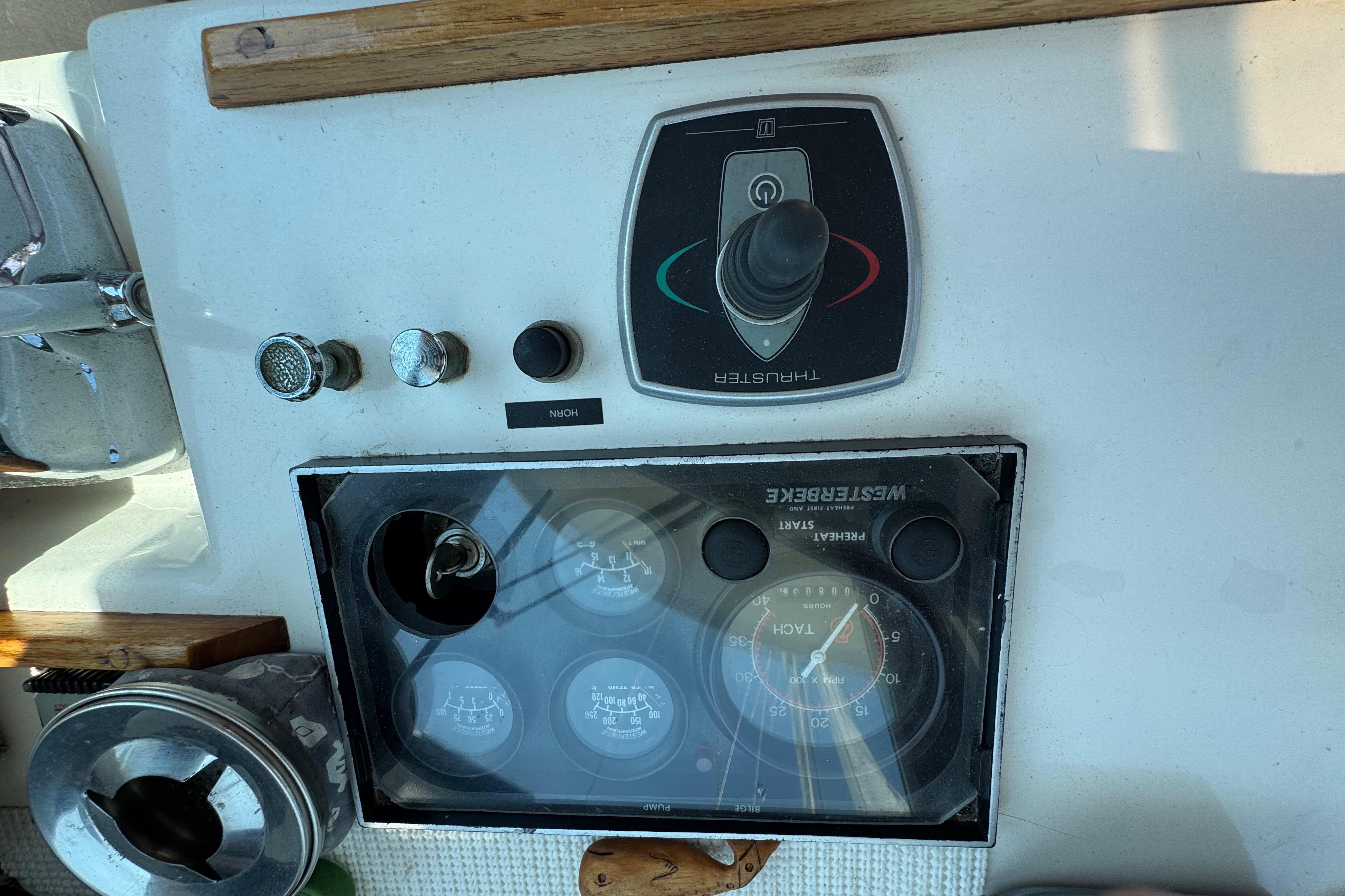 Control panel of a 1989 Cape Dory 30 Motorsailer with gauges and thruster controls.