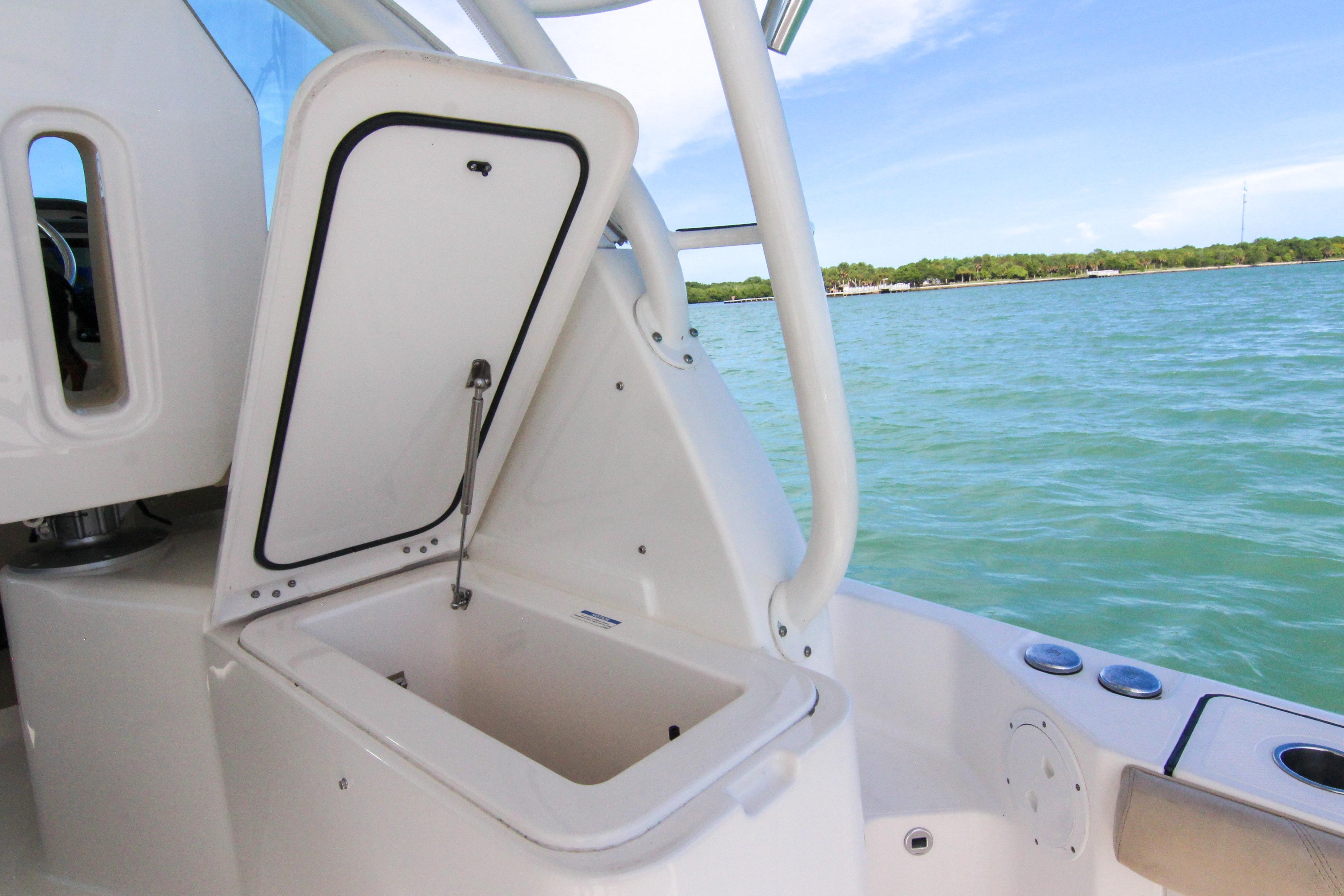 2016 Pursuit OS 385 Offshore boat with open storage compartment, ocean view.