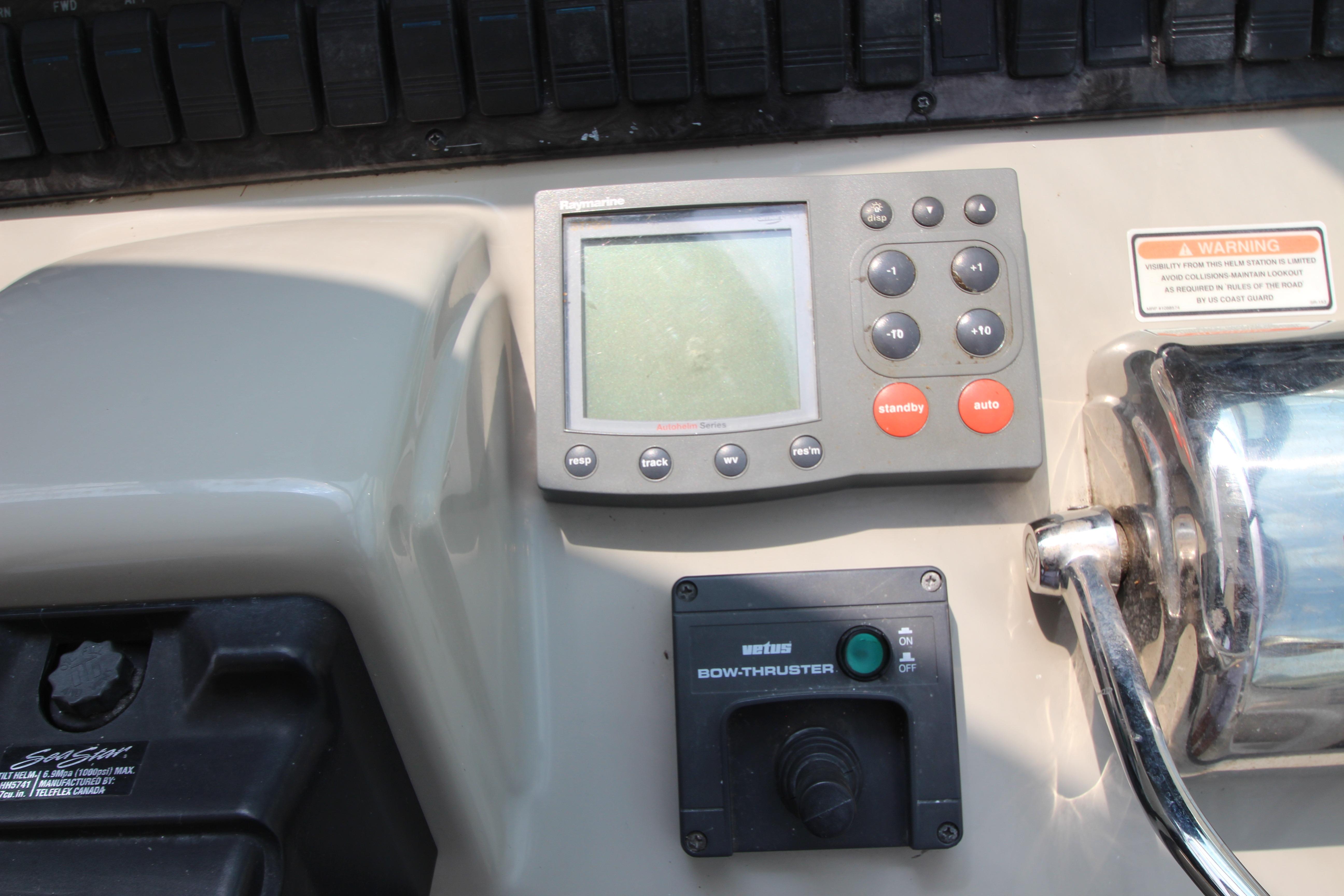 Control panel of a 2004 Sea Ray 40 Sundancer boat with navigation and bow thruster controls.