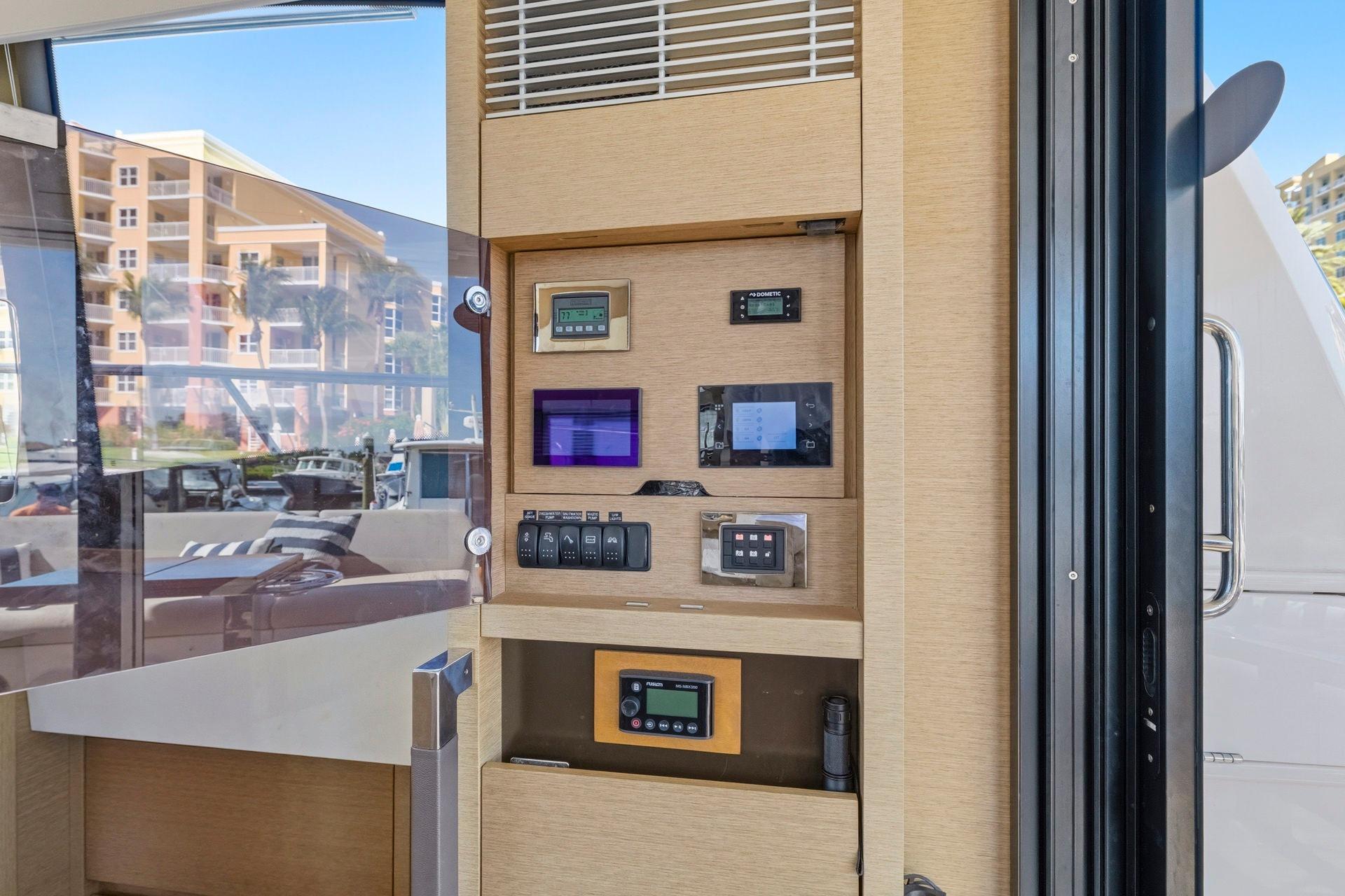 Control panel inside 2022 Prestige 520 yacht, featuring modern navigation and monitoring systems.