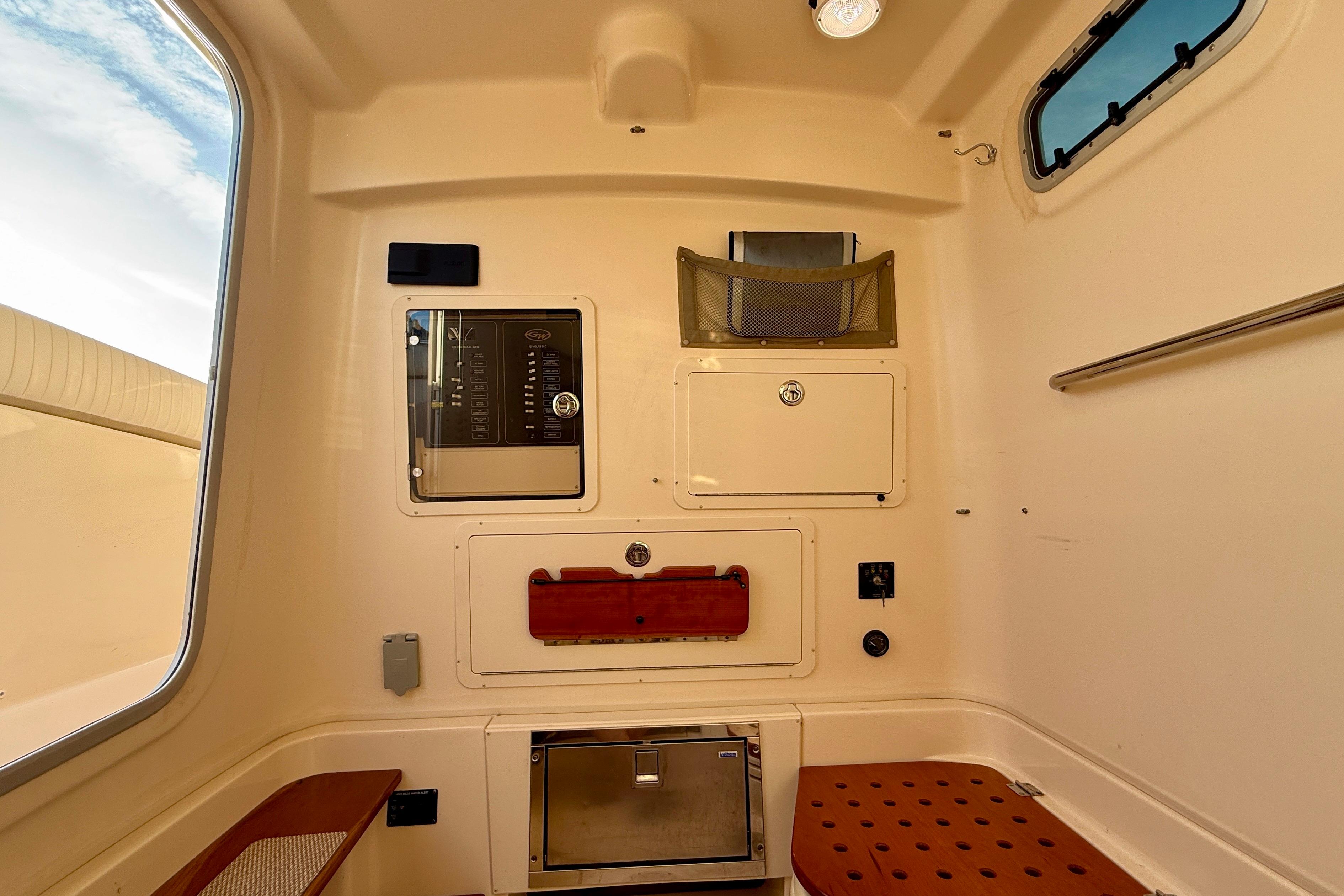 Interior cabin of 2012 Grady-White Canyon 336 boat, featuring storage compartments and seating.