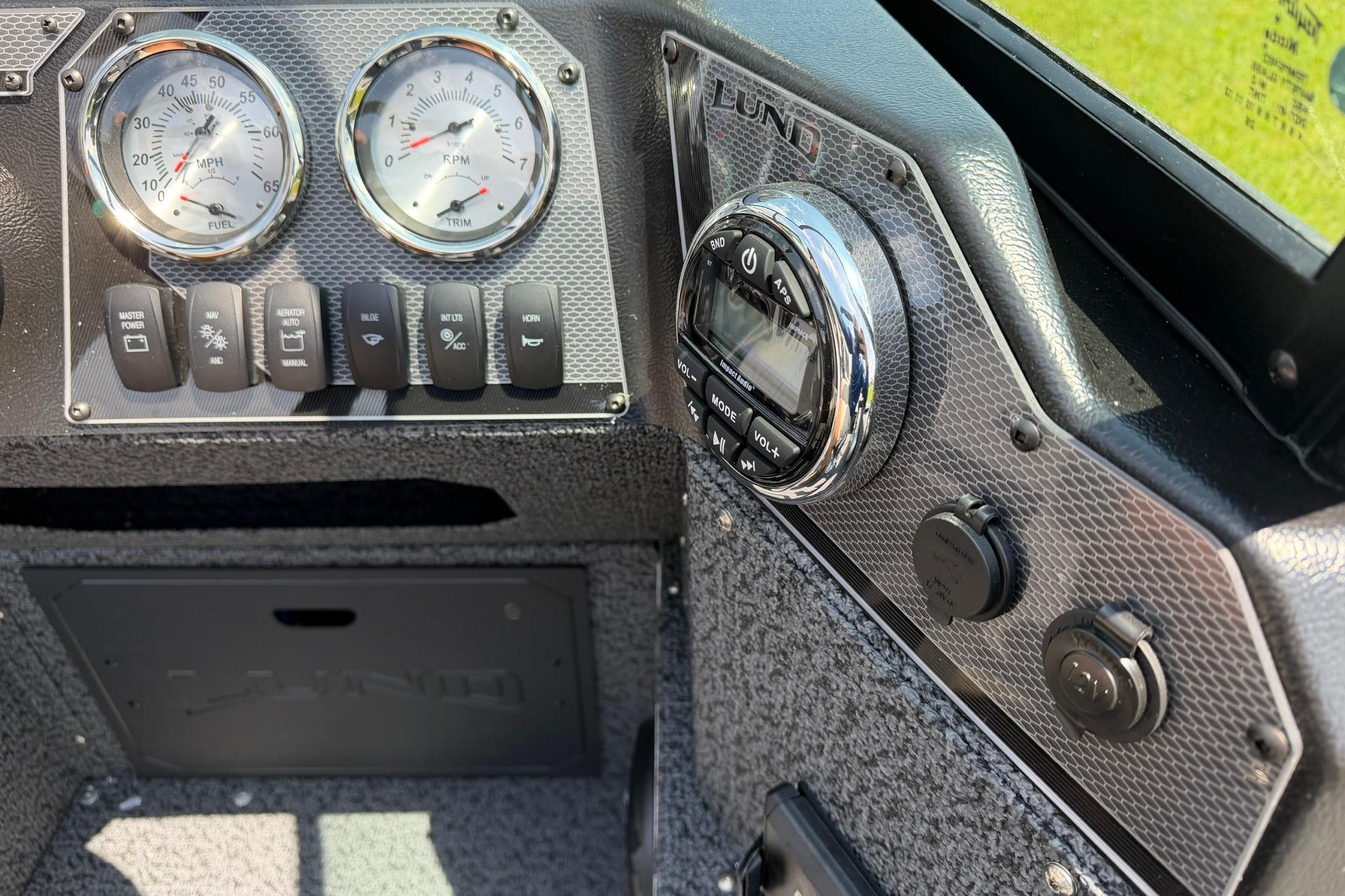 Dashboard of 2027 Lund 1675 Adventure Sport boat with gauges and controls.