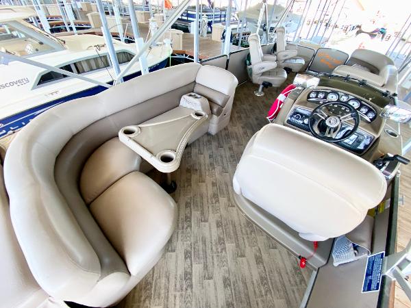 Interior of a 2011 Premier 275 Grand Majestic PTX with beige seating and a helm station.