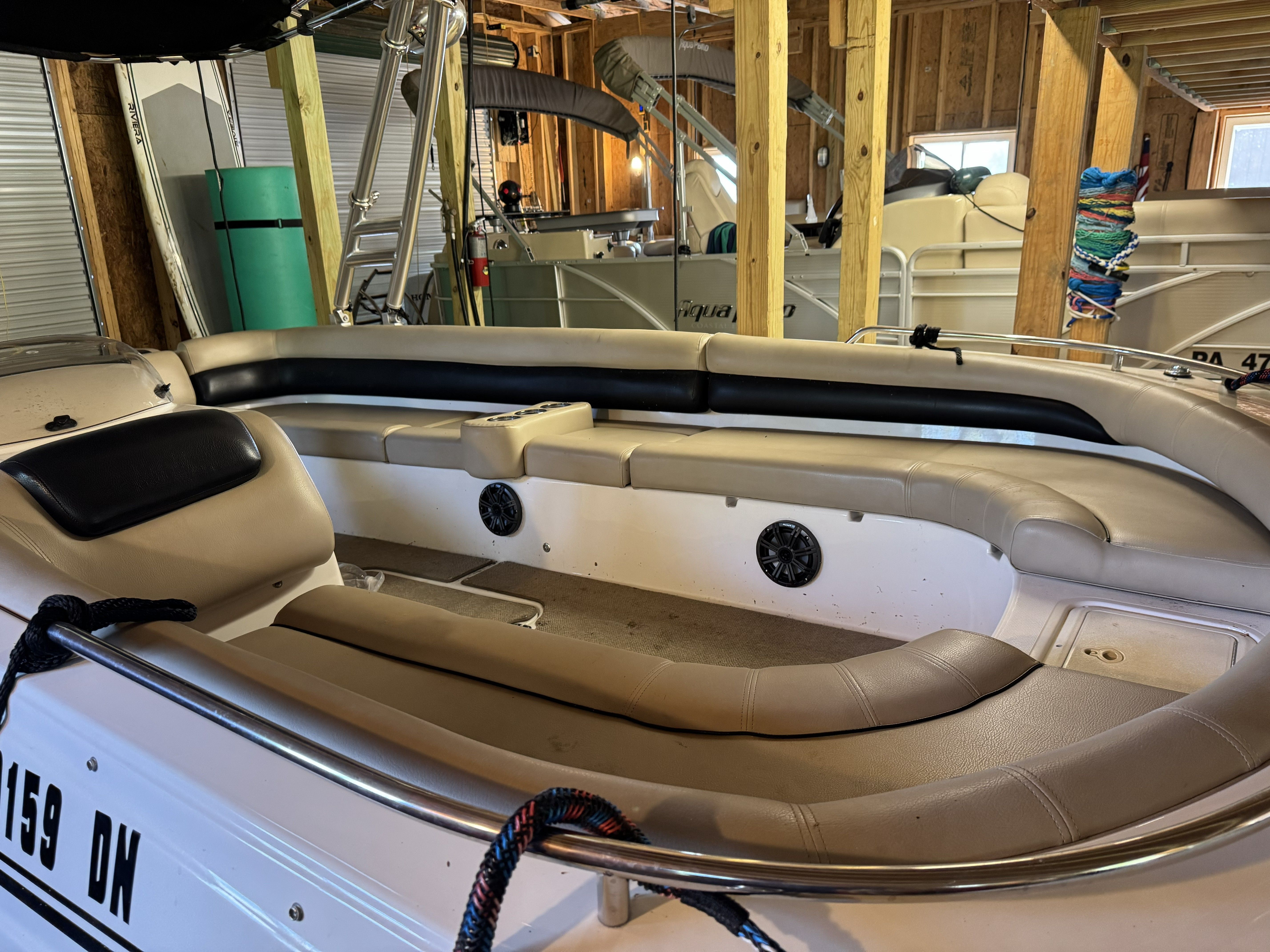 The image shows the interior of a 2014 Hurricane SS201 I/O boat with beige seating.
