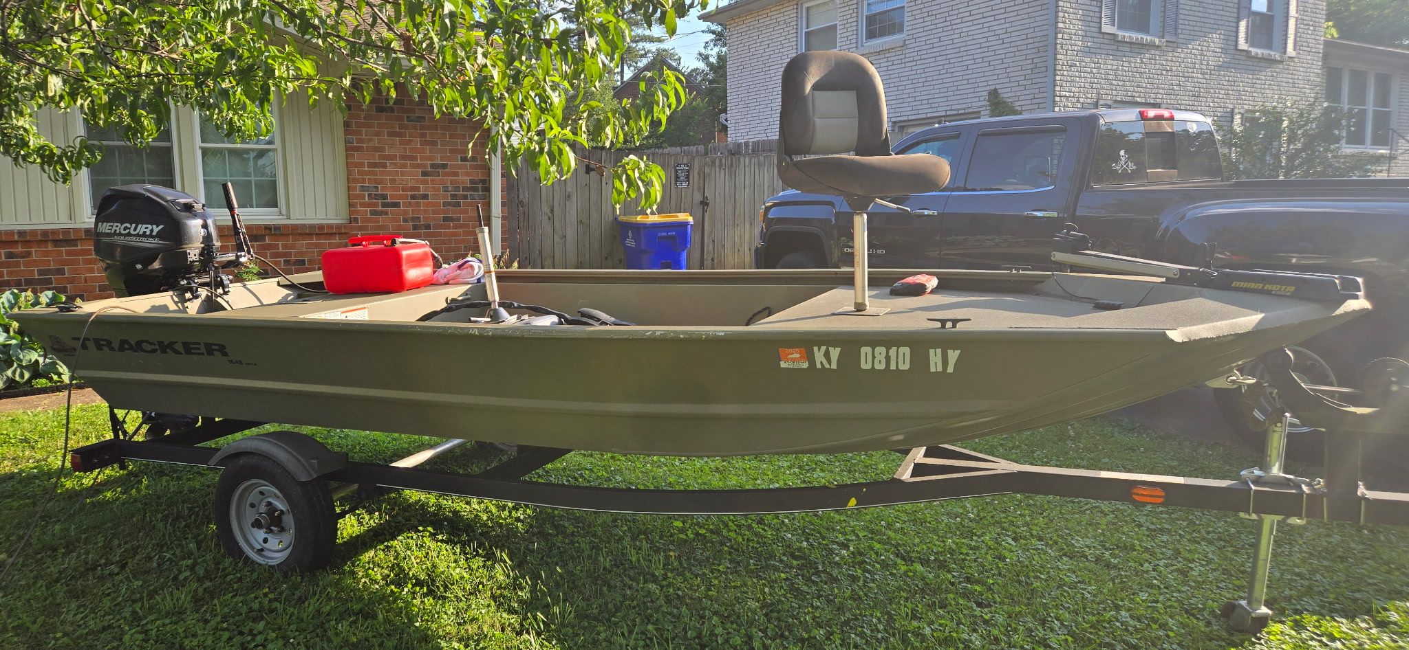 2018 Tracker Grizzly 1648 Jon on a trailer in a backyard.