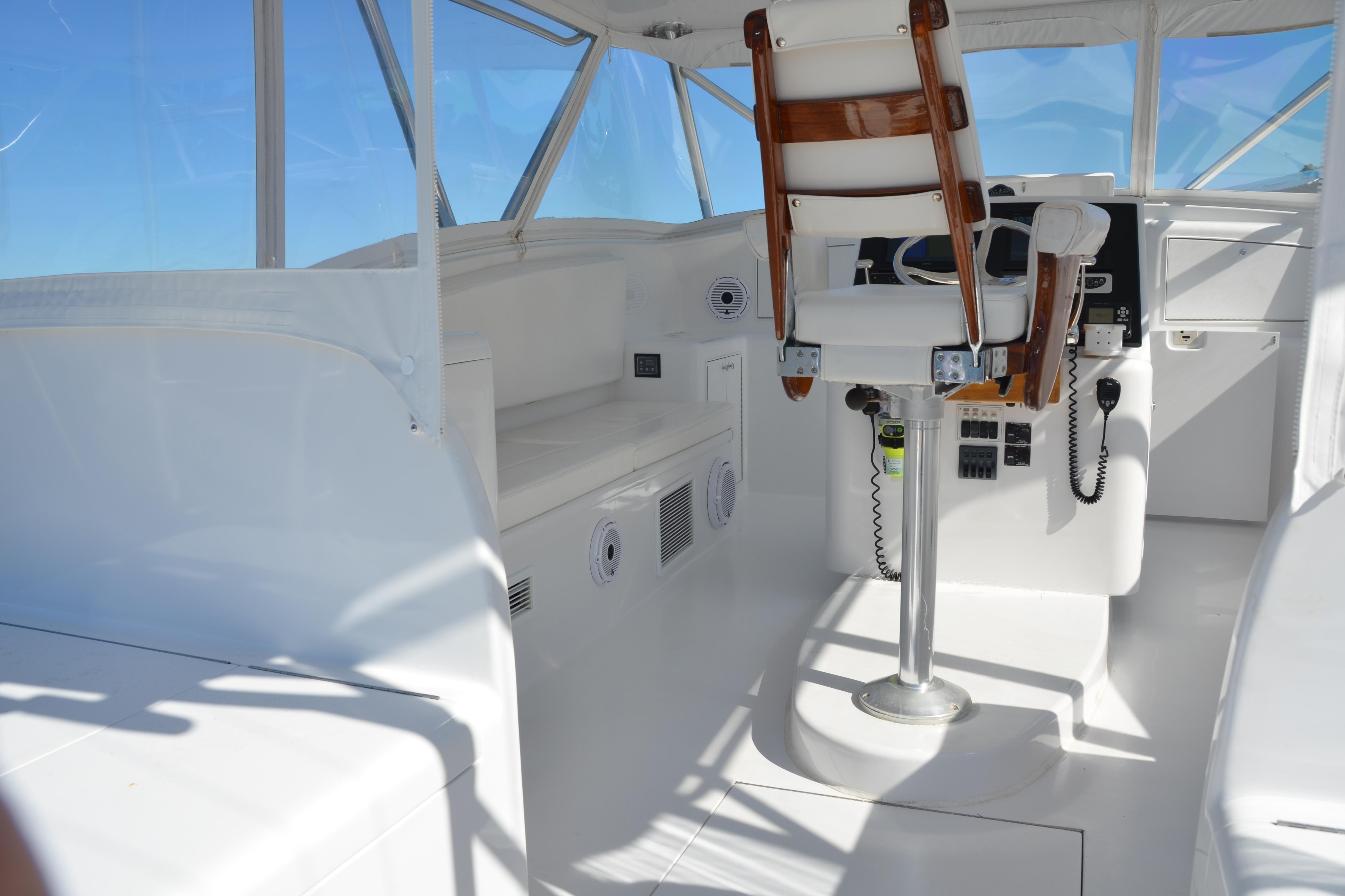 2006 Custom Carolina Heritage Express boat interior with captain's chair and control panel.