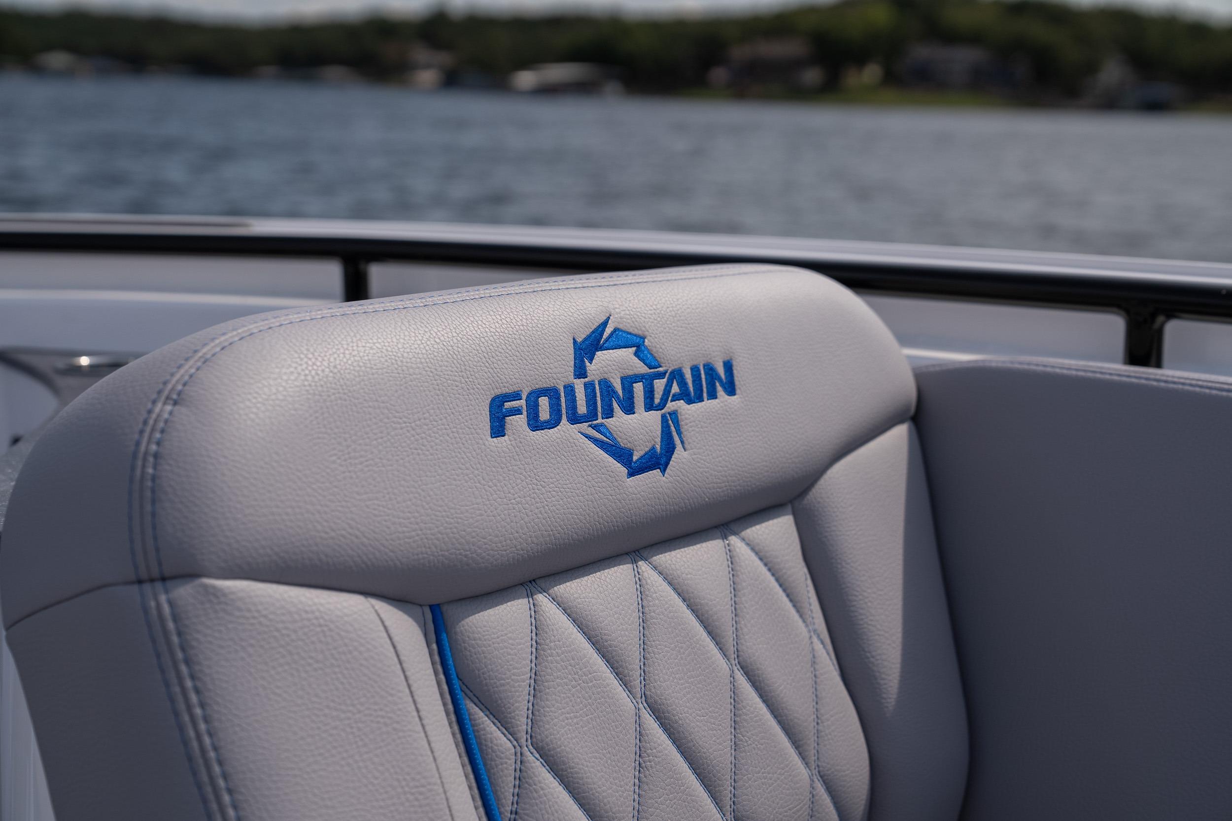 Fountain 43 SCX 2026 boat seat with logo, on a lake background.